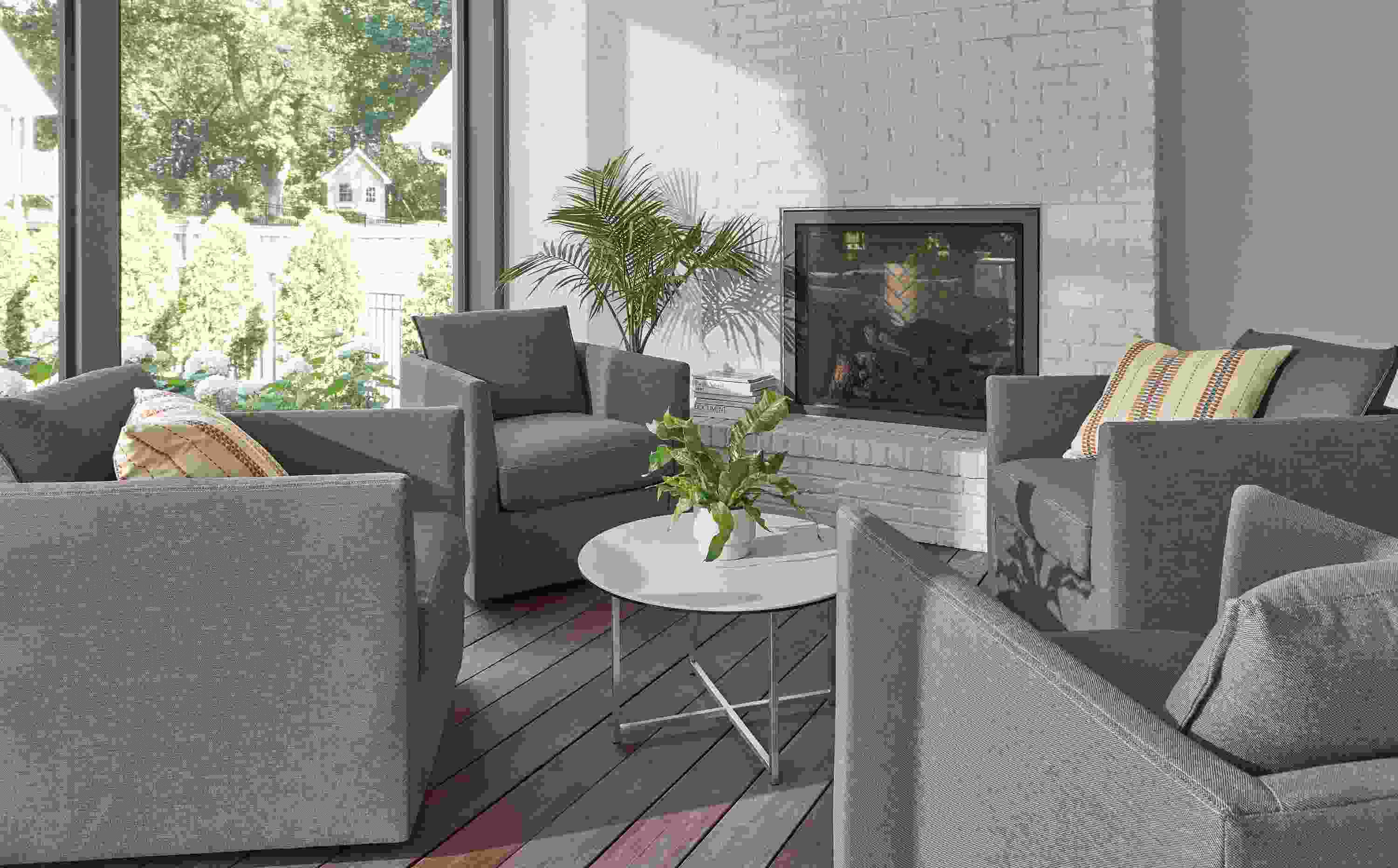 Sunroom with 4 Palm outdoor swivel chairs in Pelham grey with Classic 27-round outdoor coffee table.
