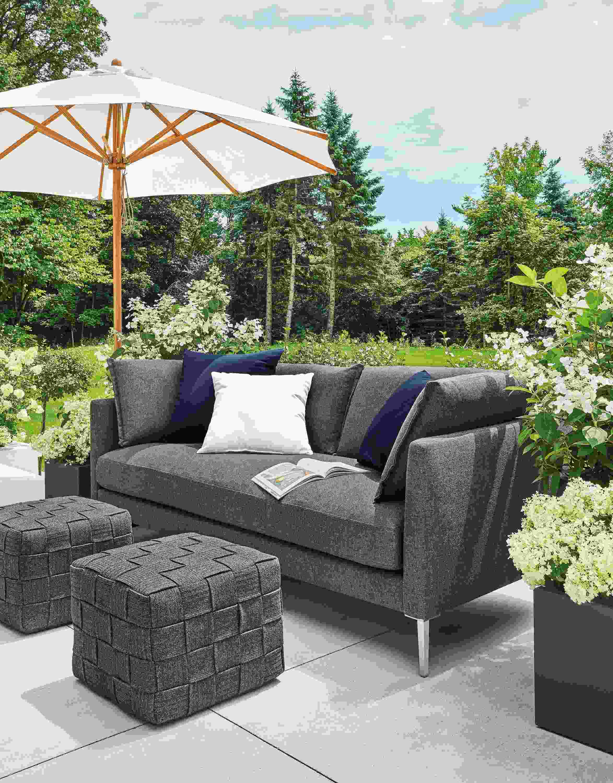 Detail of Palm sofa and Flet ottomans on patio with Cirro umbrella.