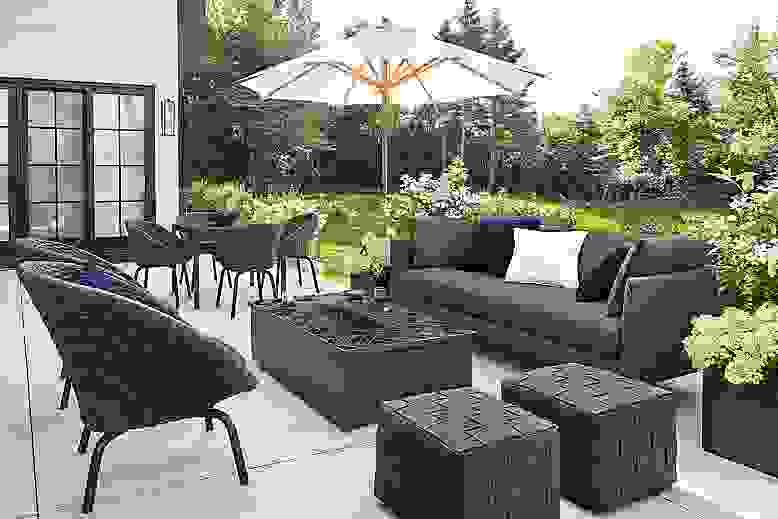 Detail of Palm sofa with Flet lounge chairs and Flet ottomans and Adara tile top fire table on patio.