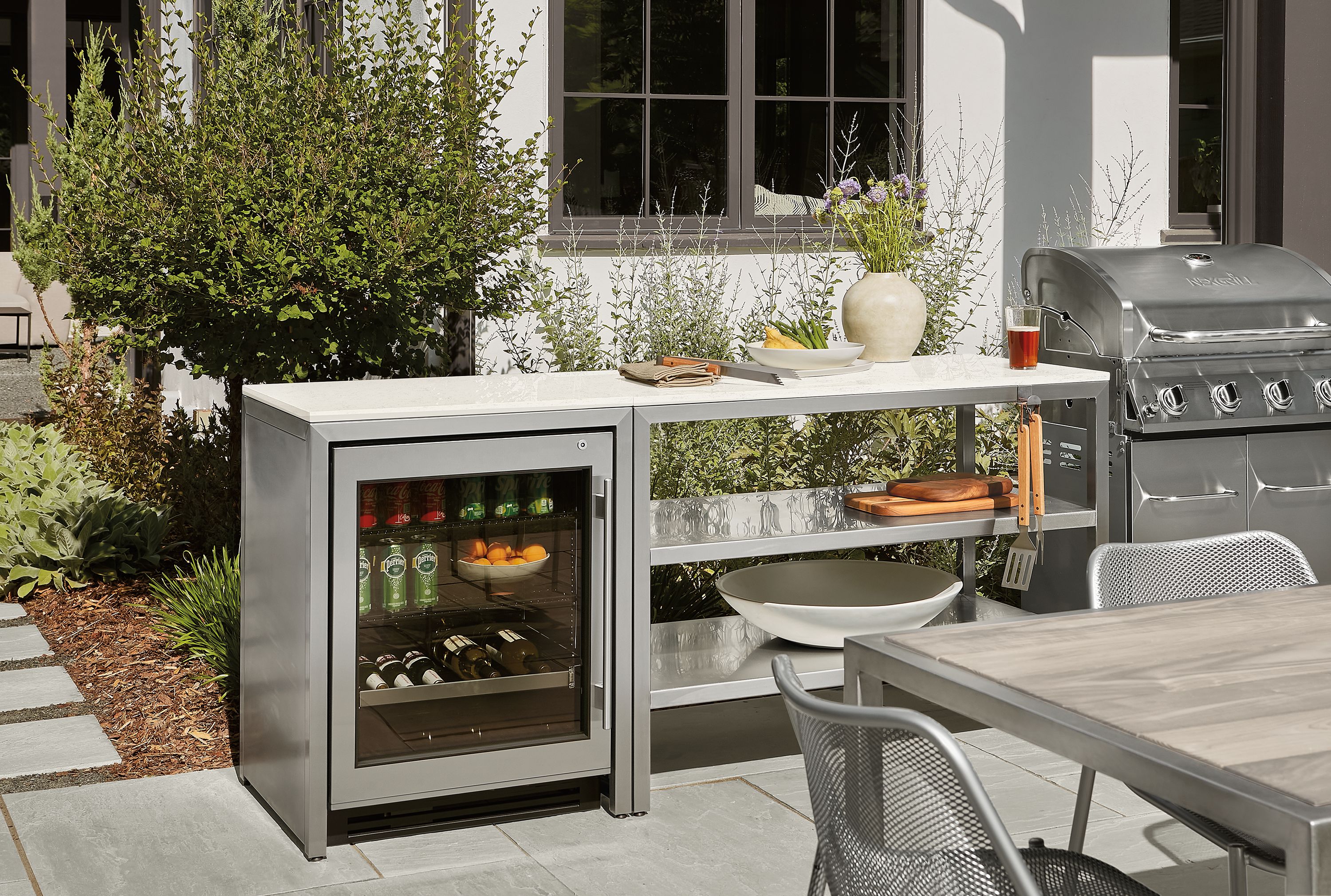 Outdoor space with parsons modular outdoor kitchen with fridge and montego in aged thermally modified ash.