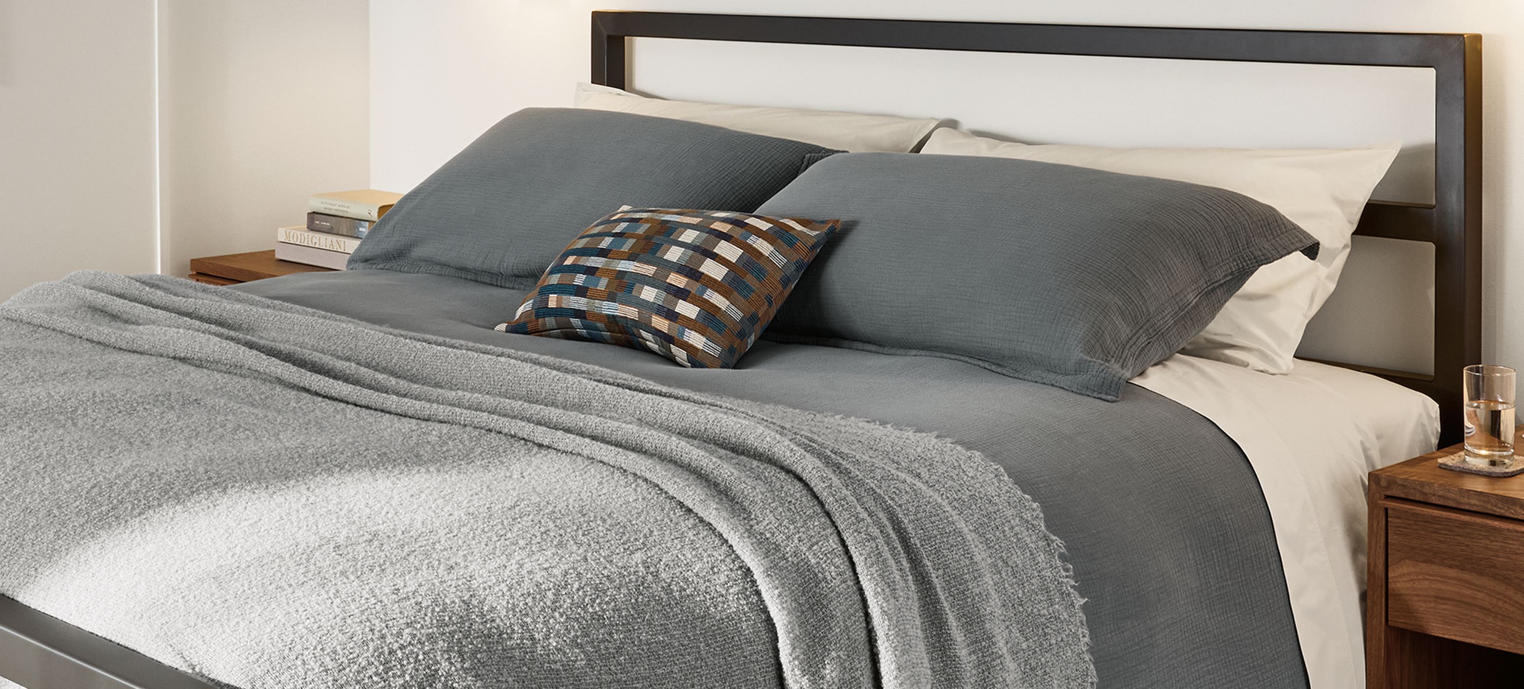 Bedroom with Parsons king bed in natural steel, Safira rug in putty and Strand king duvet set in dusk.