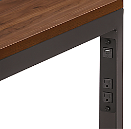Detail of Parsons desk  in natural steel with usb and  power cord outlets.