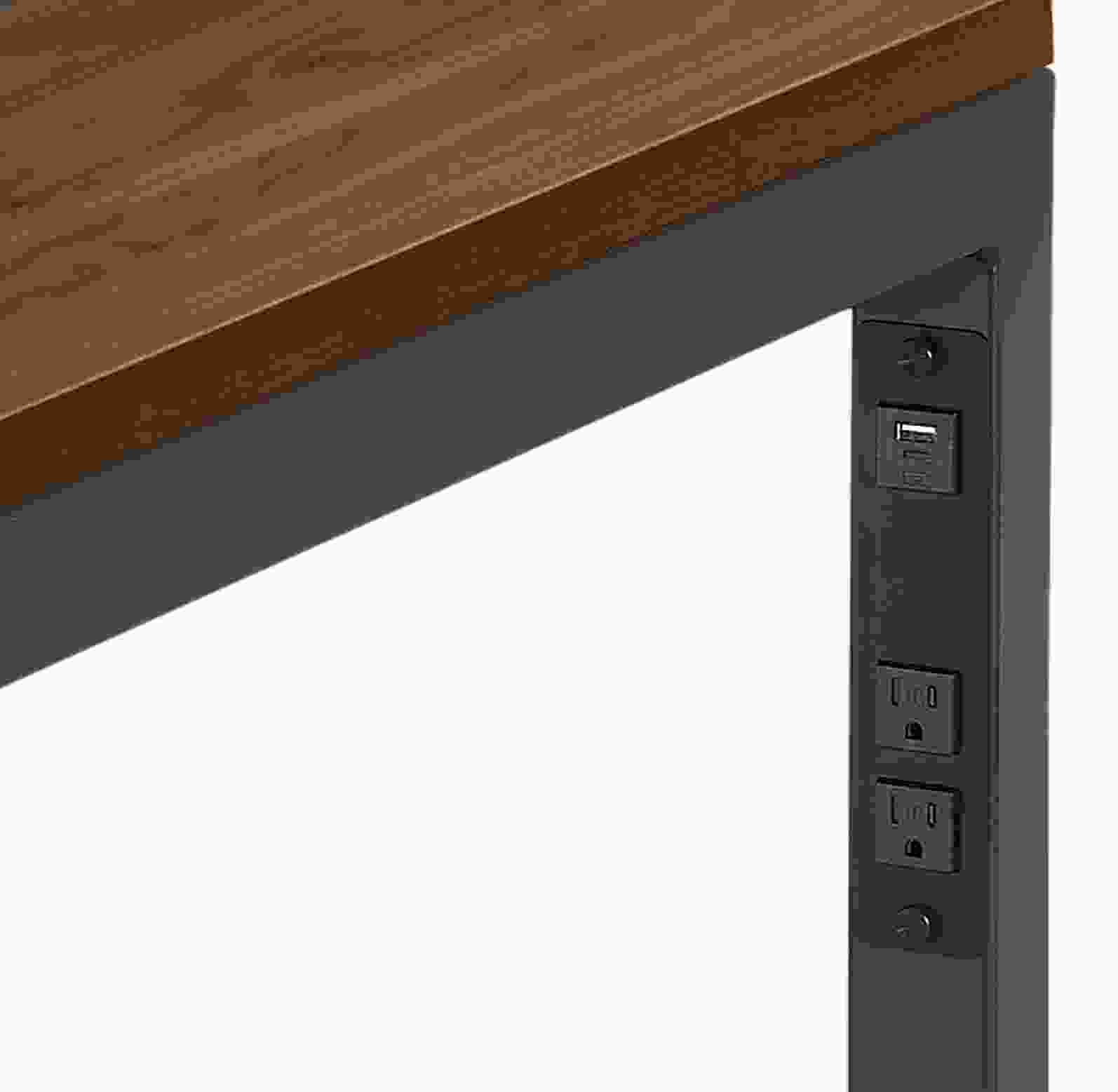Detail of Parsons desk  in natural steel with usb and  power cord outlets.