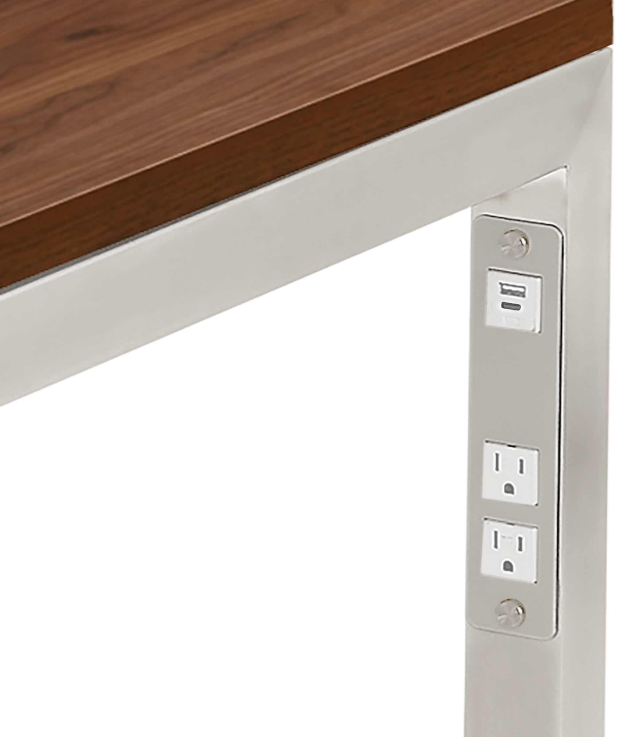 Detail of Parsons desk  in stainless steel with usb and  power cord outlets.
