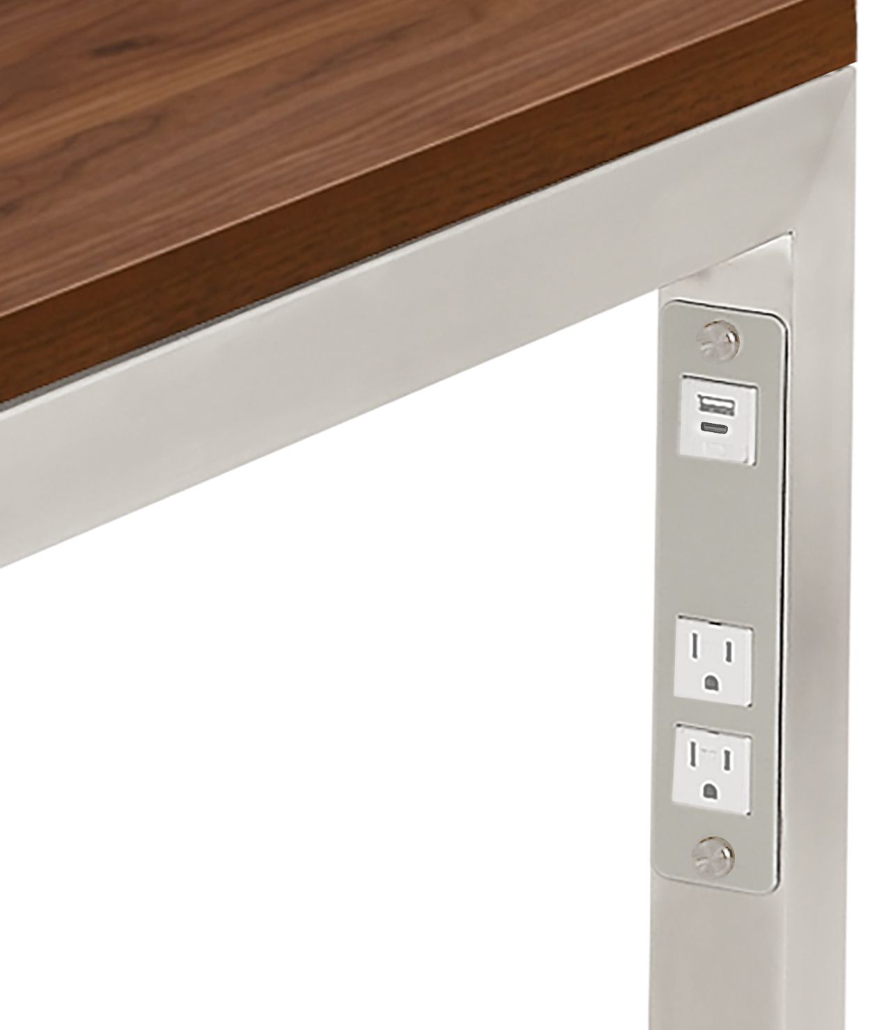 Detail of Parsons desk  in stainless steel with usb and  power cord outlets.