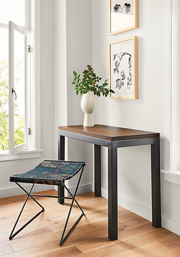 Detail of Parsons natural steel table with walnut top in entryway.