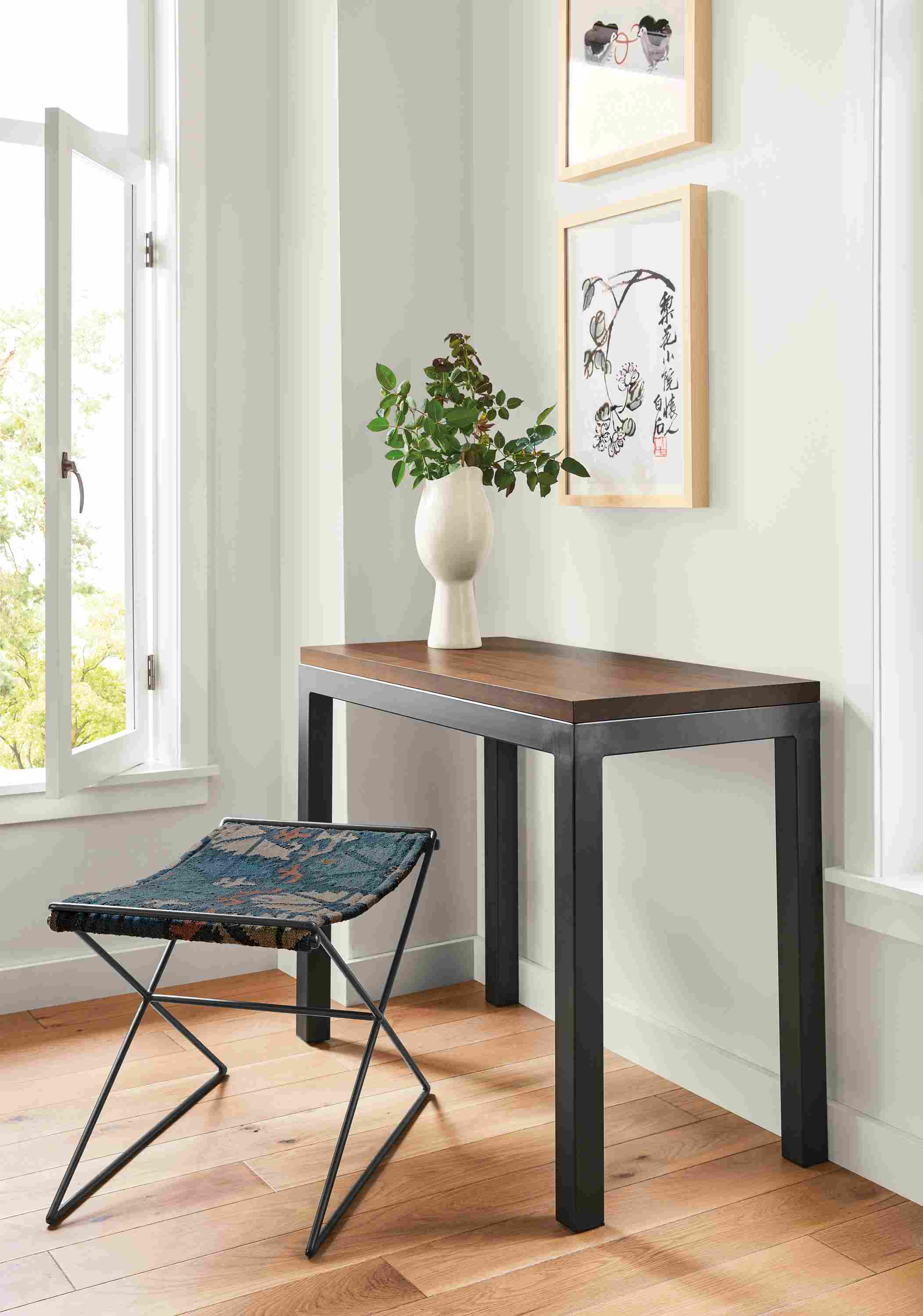 Detail of Parsons natural steel table with walnut top in entryway.