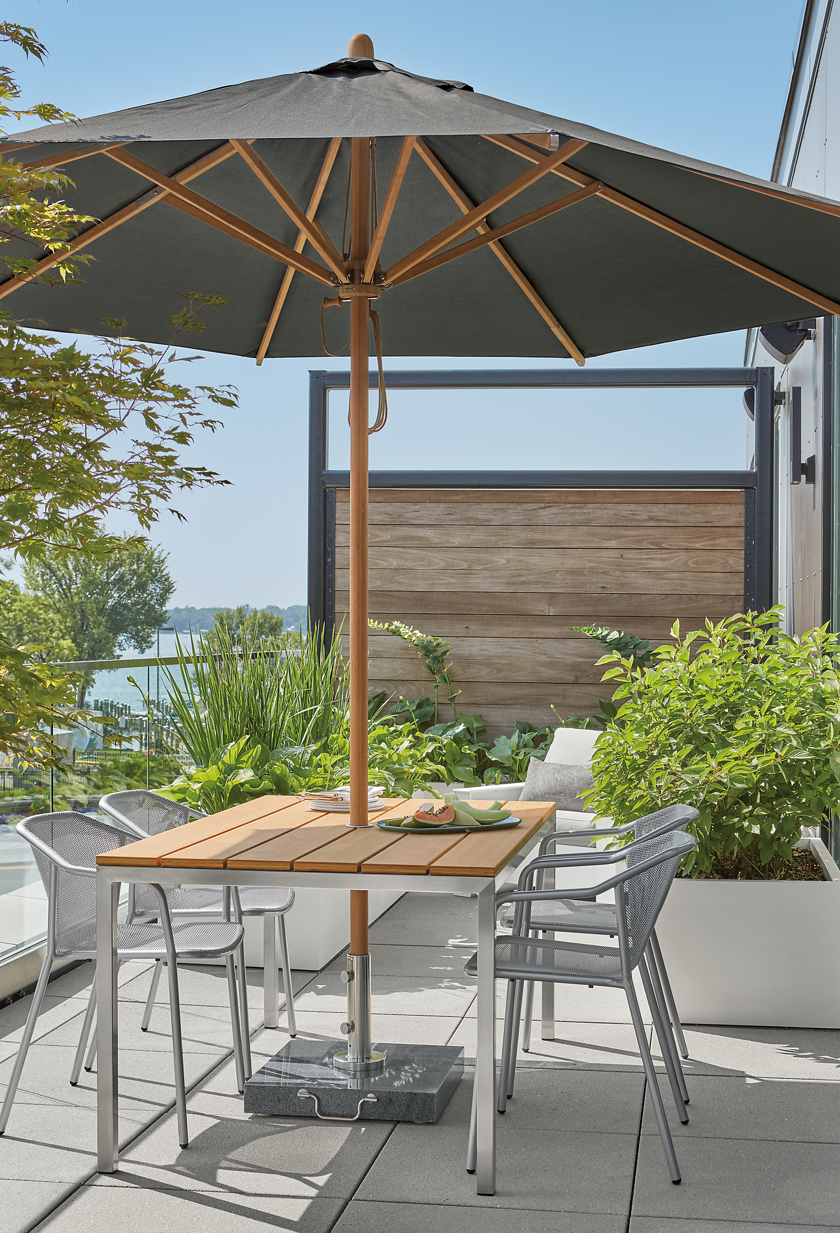 Parsons 60-wide outdoor table, Theo chairs and Cirro patio umbrella.