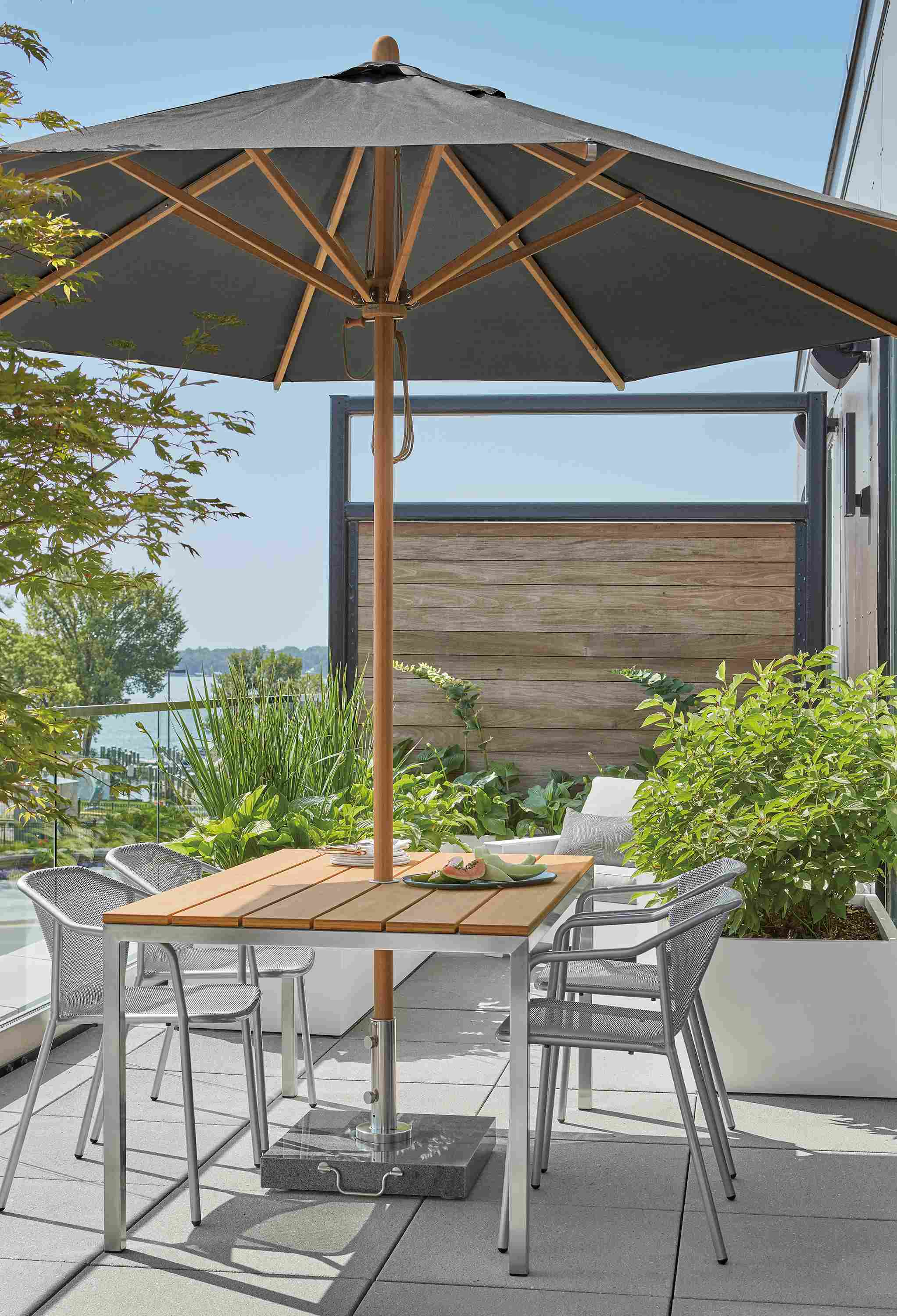 Parsons 60-wide outdoor table, Theo chairs and Cirro patio umbrella.