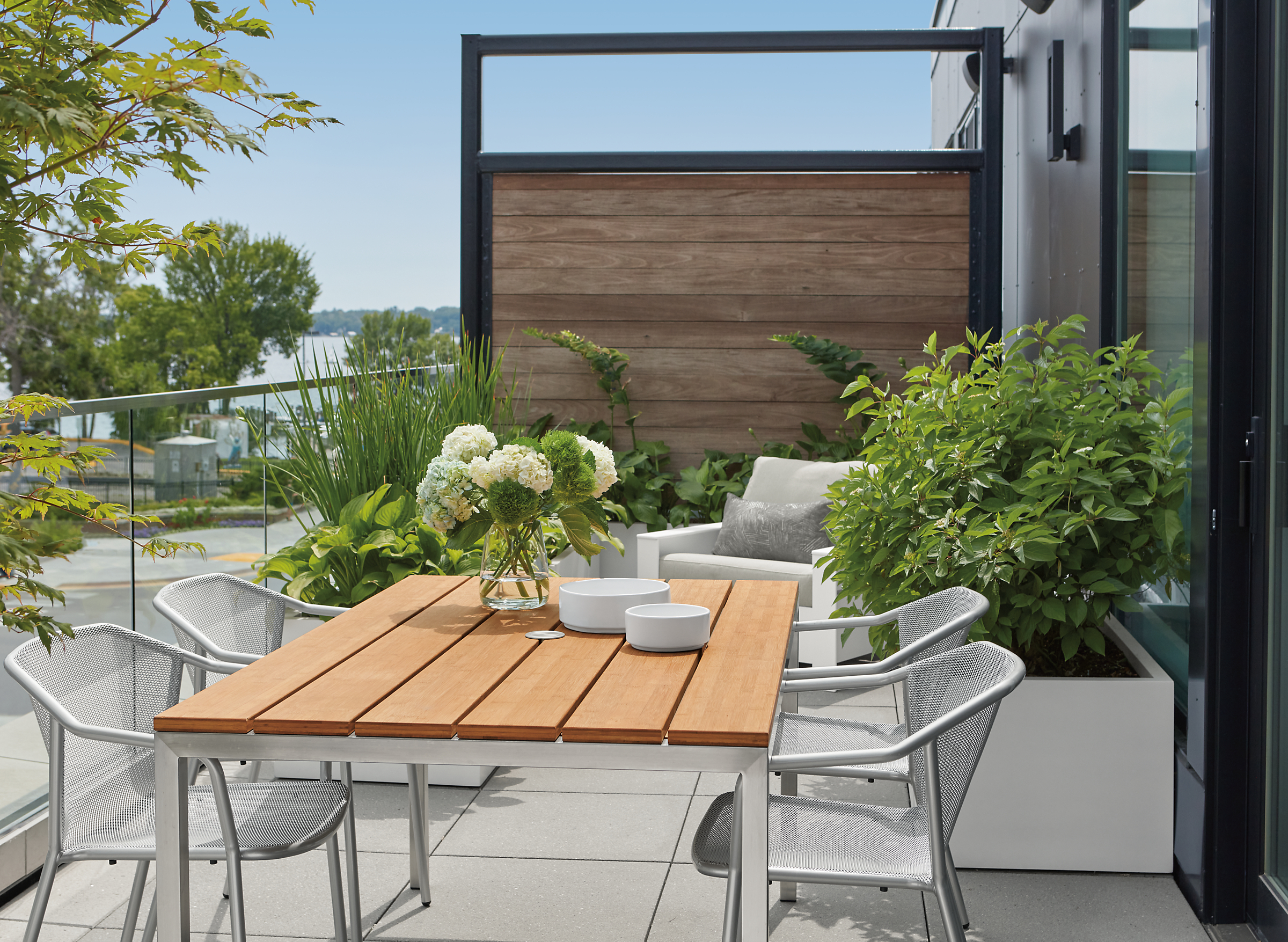 Outdoor patio with Parsons 60-wide outdoor table with four Theo chairs.