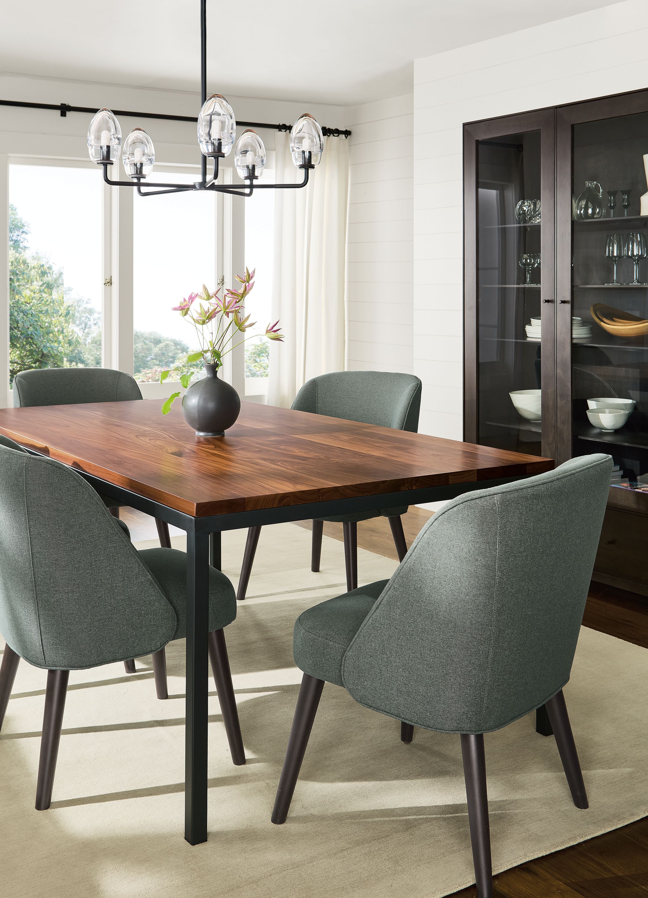 Dining room with parsons table in walnut and natural steel and 4 cora side chairs in myers pine with charcoal legs and luco rug in silver.
