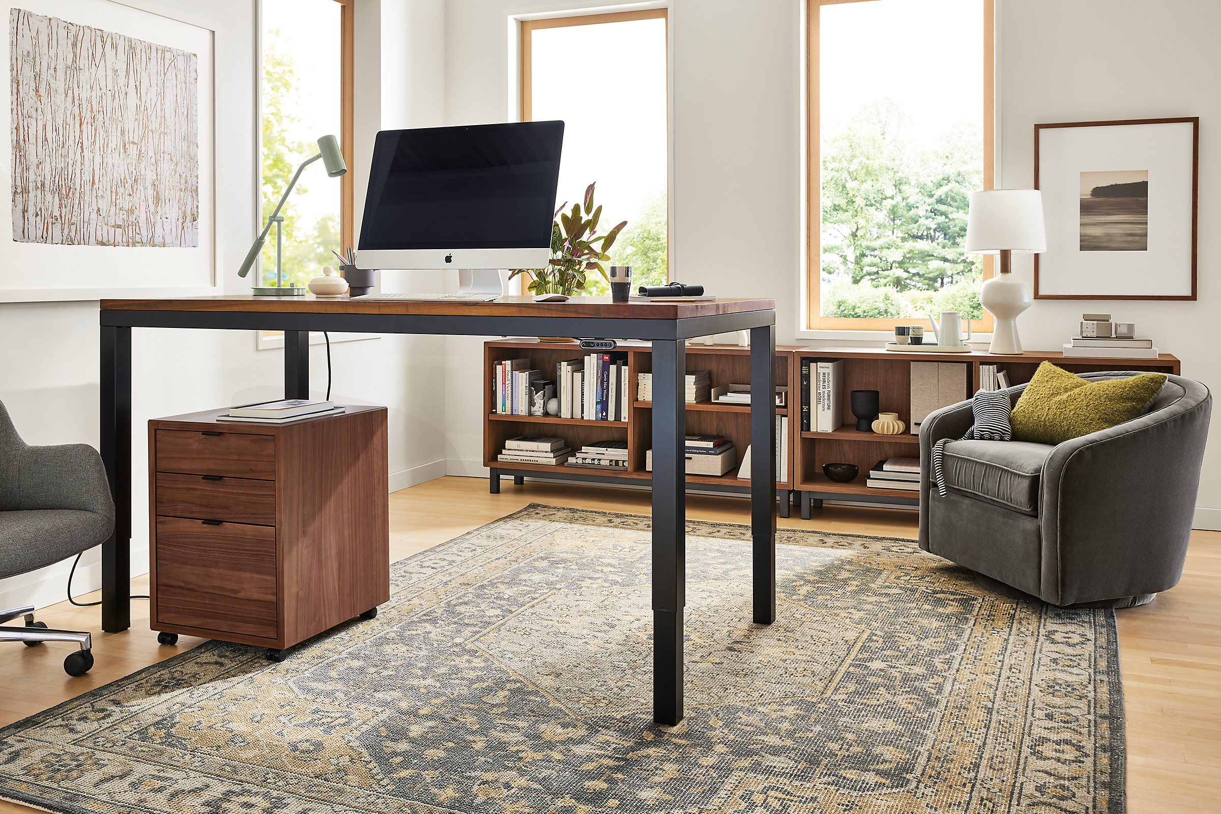 Office area with Parsons Adjustable height standing desk in graphite and walnut in standing position, Copenhagen file cabinet and Veda rug.