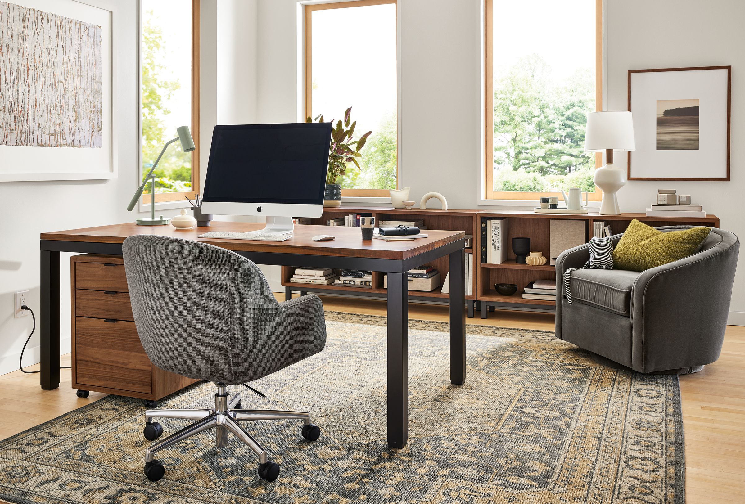 Office area with Parsons Adjustable height standing desk in graphite and walnut in seated position, Nico office chair and Veda rug.