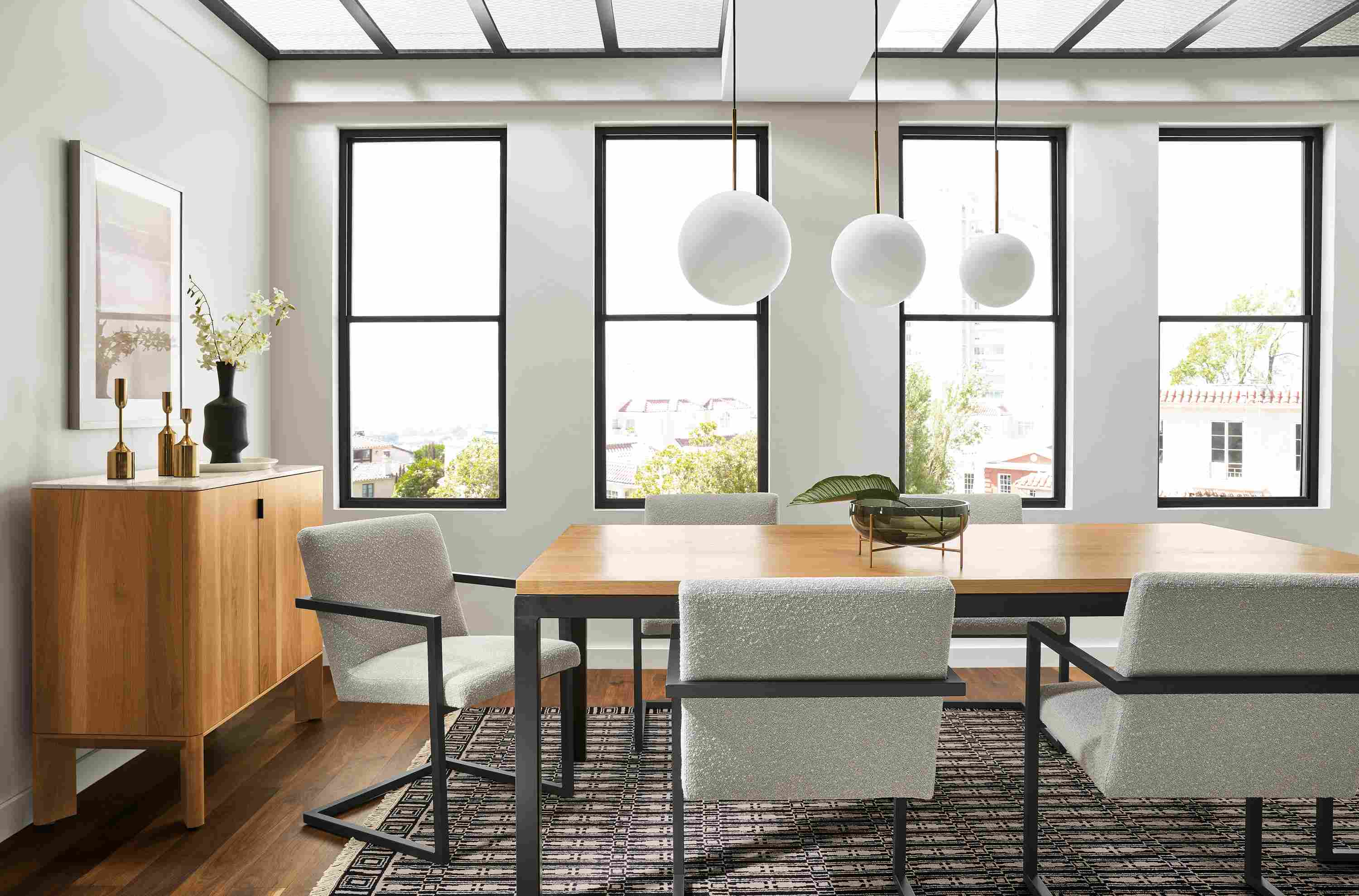 Conference room with Parsons 78 by 42 Table in natural steel and white oak, Lira chairs in graphite and Declan fabric and Pren 40-wide bar cabinet.