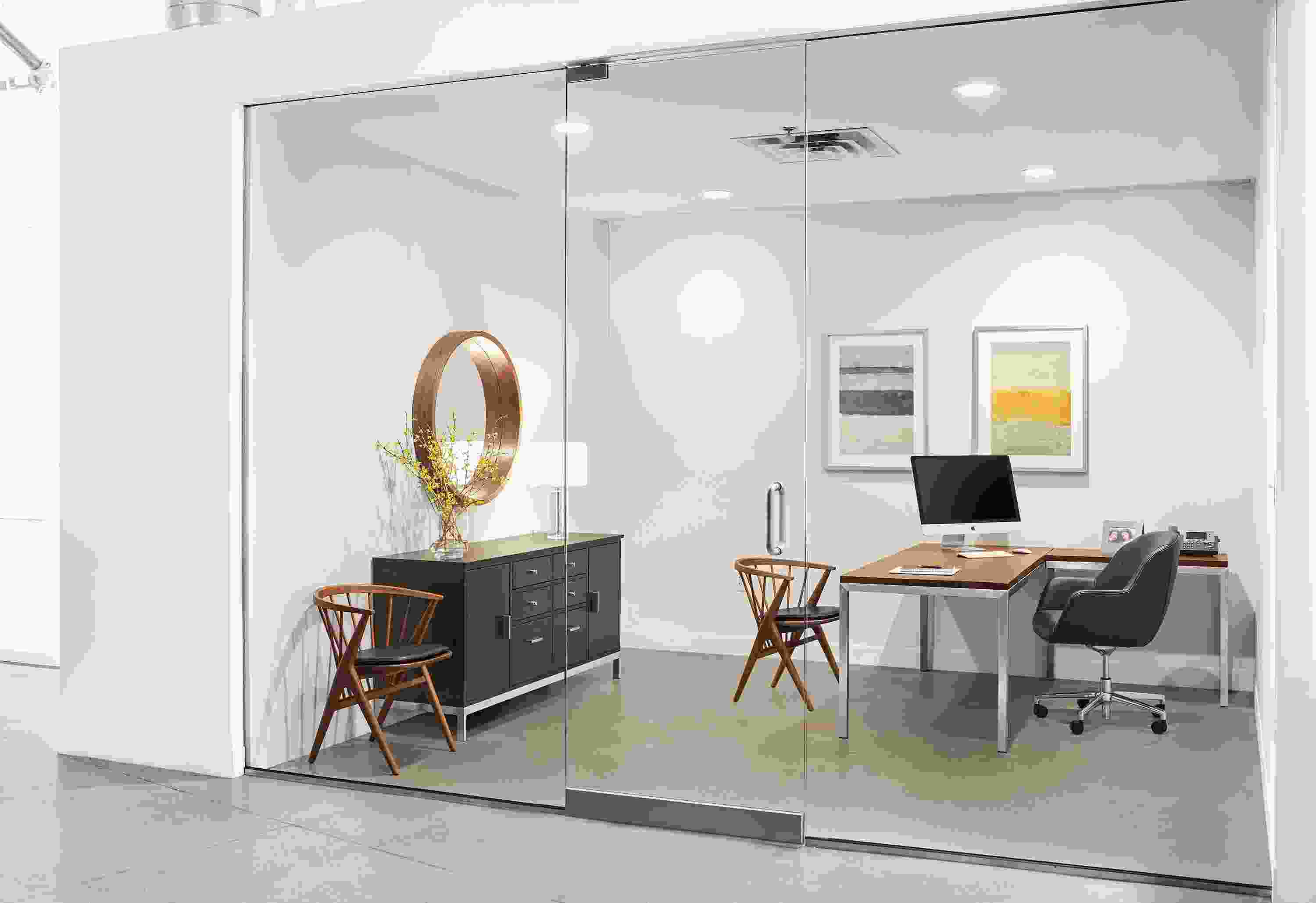 Office with detail of Parsons in Stainless Steel L-shaped desk with walnut top.