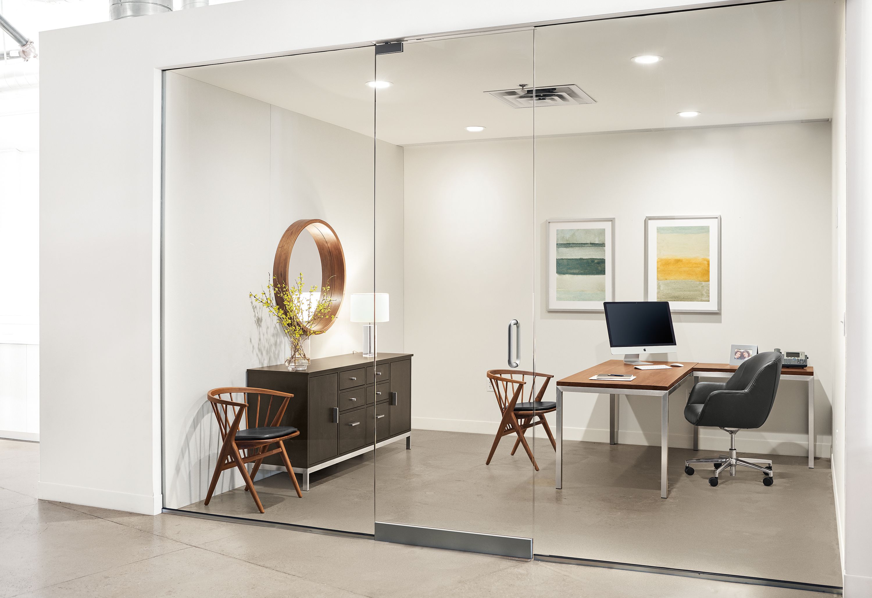 Office with detail of Parsons in Stainless Steel L-shaped desk with walnut top.