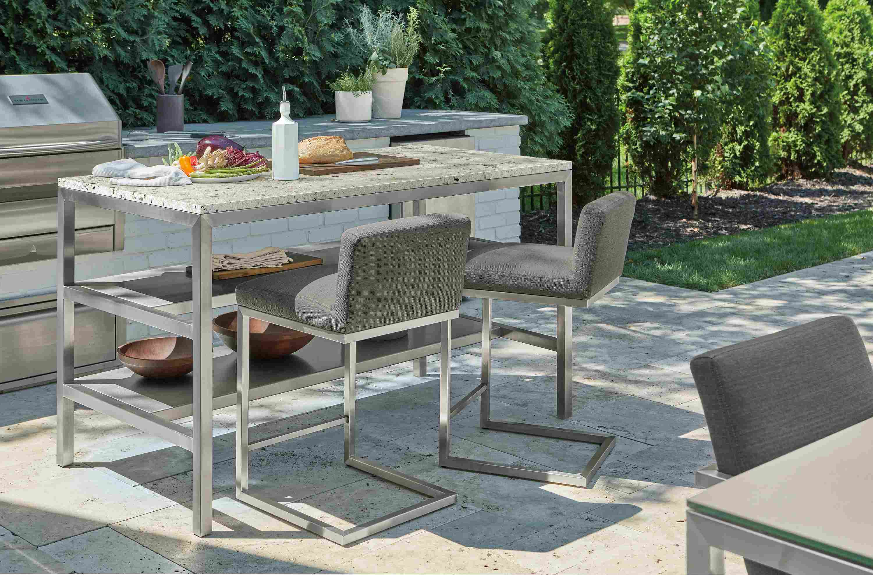 Parsons 60-wide outdoor counter table with 2 narrow shelves and two Finn counter stools in Pelham Grey.