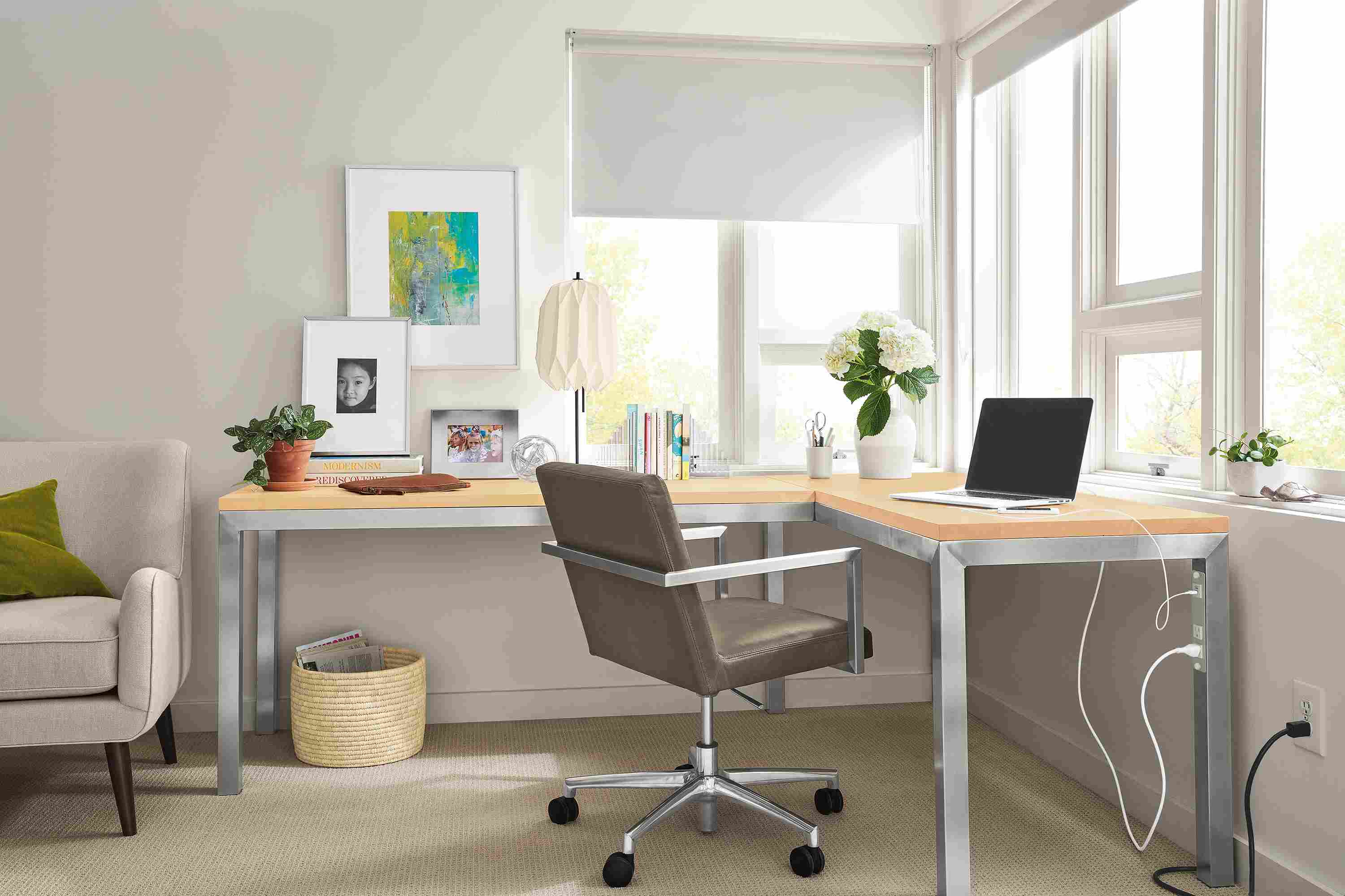 Office area with Parsons L-shaped desk in stainless steel with maple top and Lira office chair.
