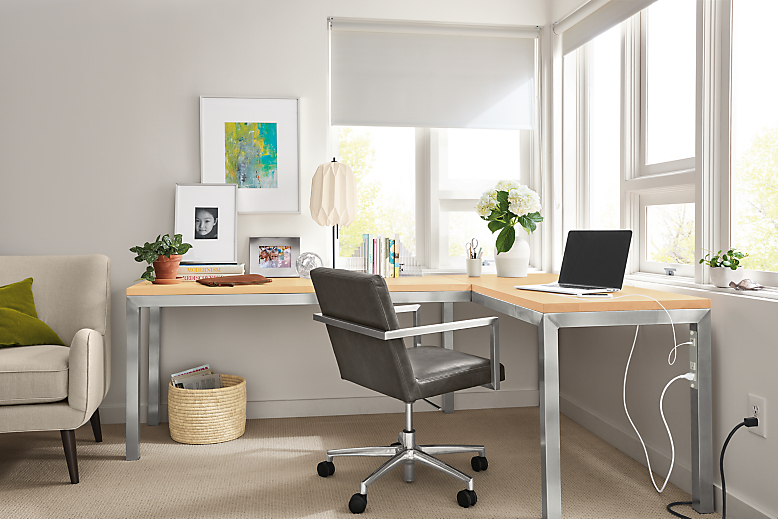 Office area with Parsons L-shaped desk in stainless steel with maple top and Lira office chair.