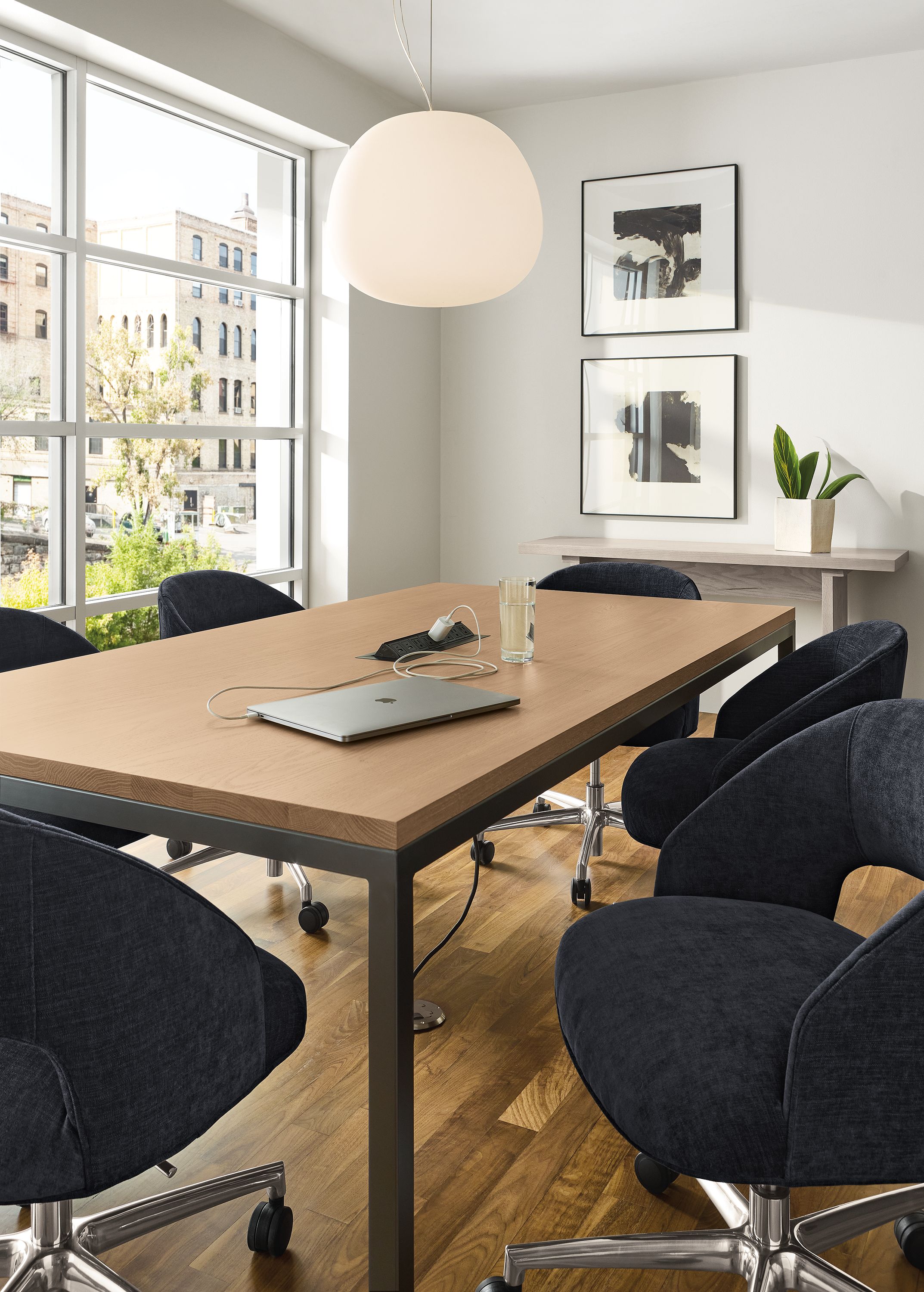 Conference room with Parsons 78-wide table with 8-port charging outlet in rye on red oak and natural steel.