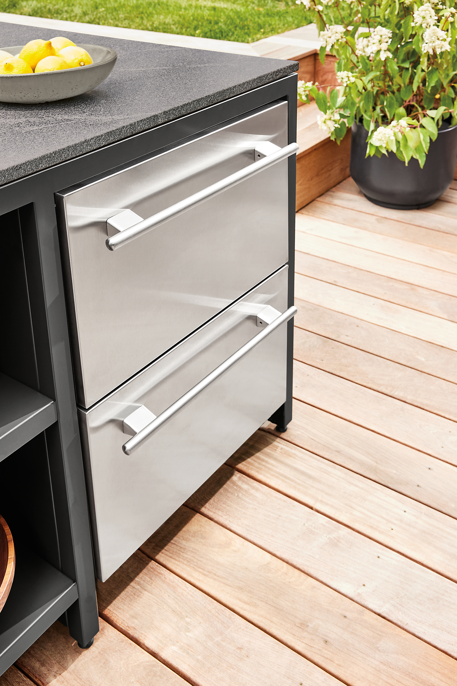 detail of outdoor fridge with drawers in parsons counter table in outdoor space.