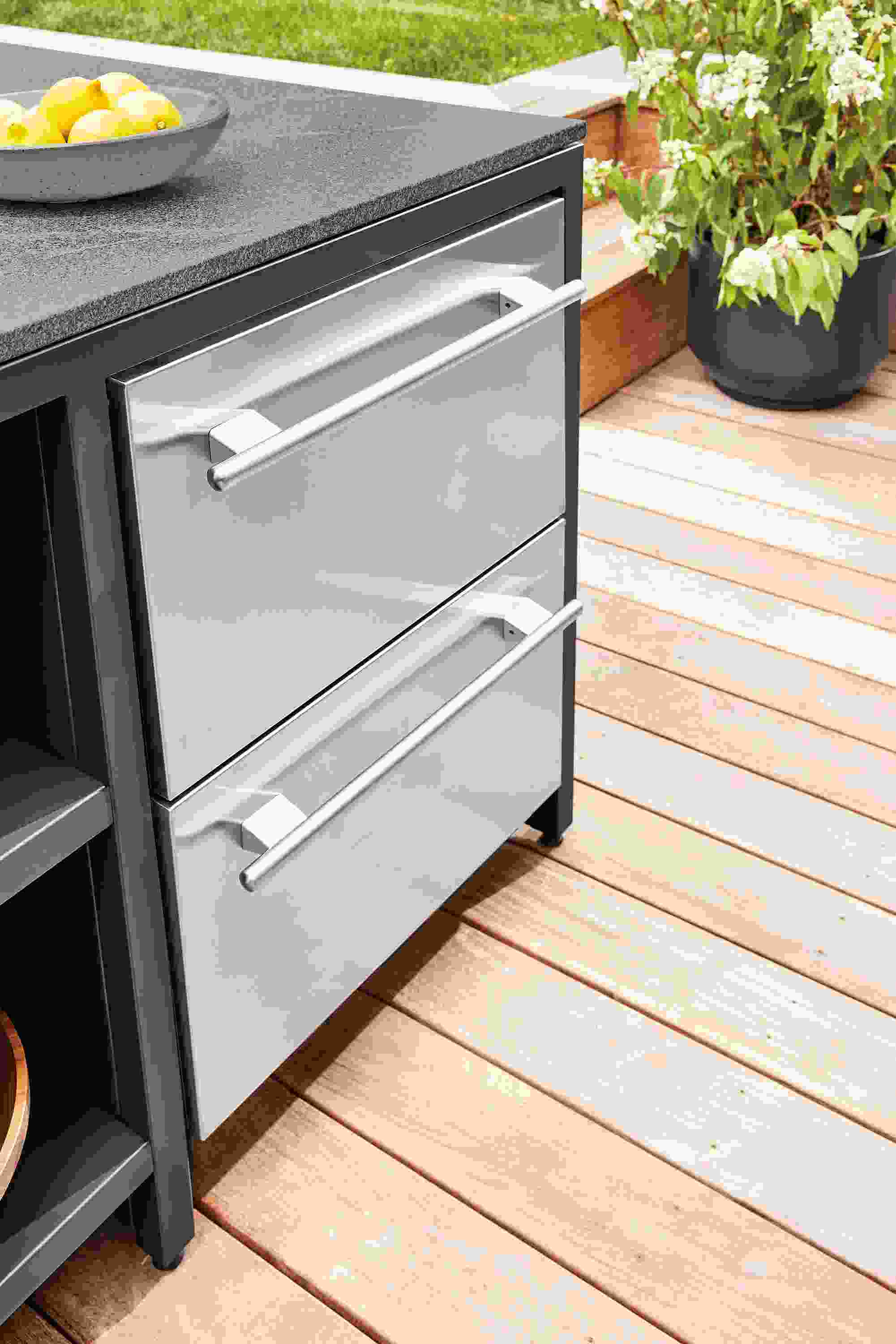detail of outdoor fridge with drawers in parsons counter table in outdoor space.