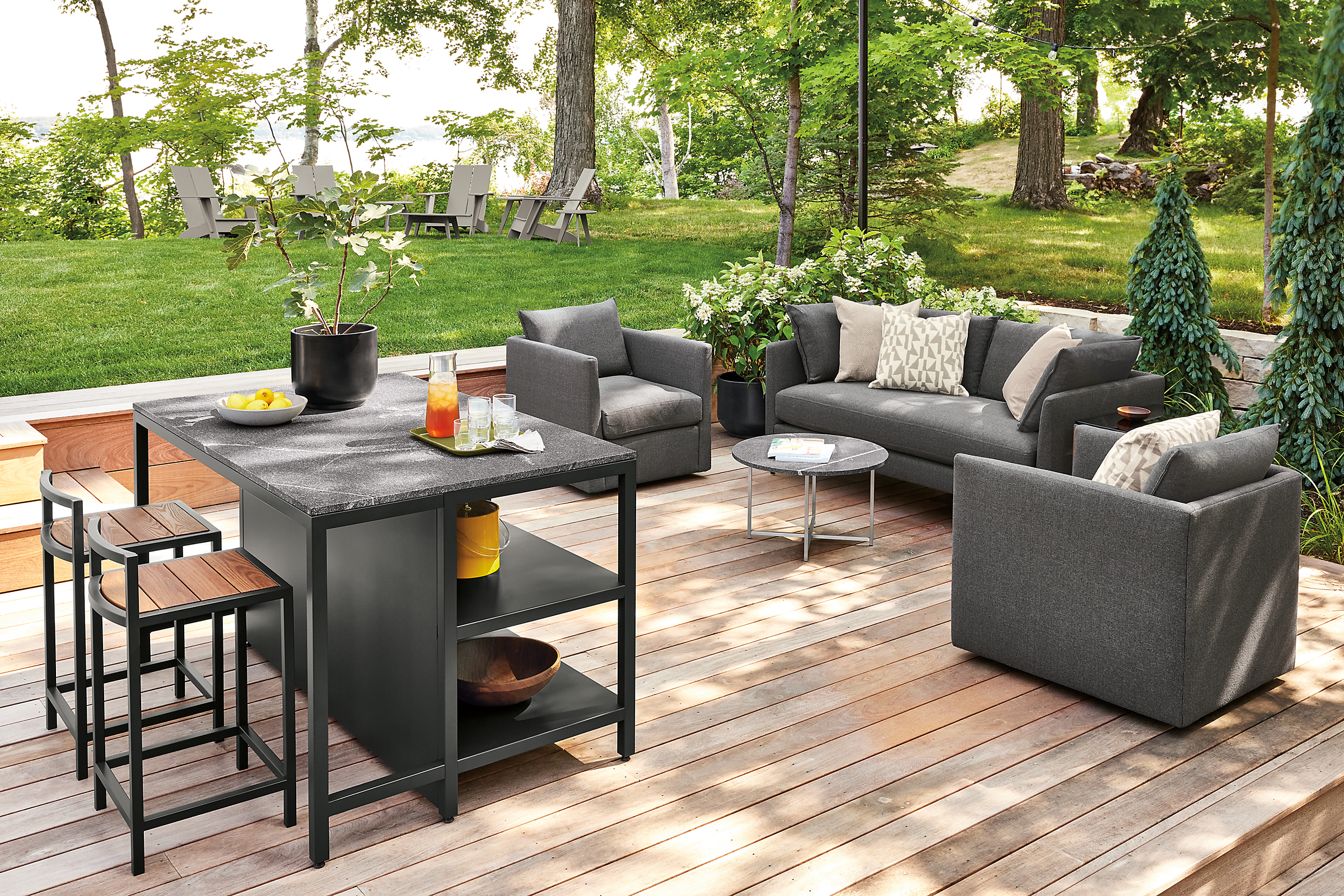 Outdoor space with parsons outdoor counter table, montego stools, palm lounge furniture.
