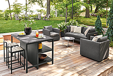 Outdoor space with parsons outdoor counter table, montego stools, palm lounge furniture.