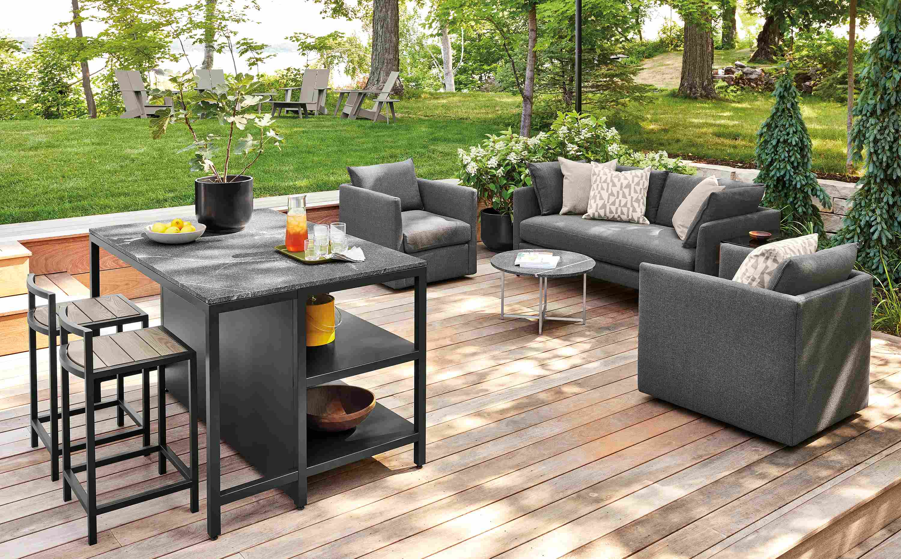 Outdoor space with parsons outdoor counter table, montego stools and Palm sofa in Mist Charcoal.
