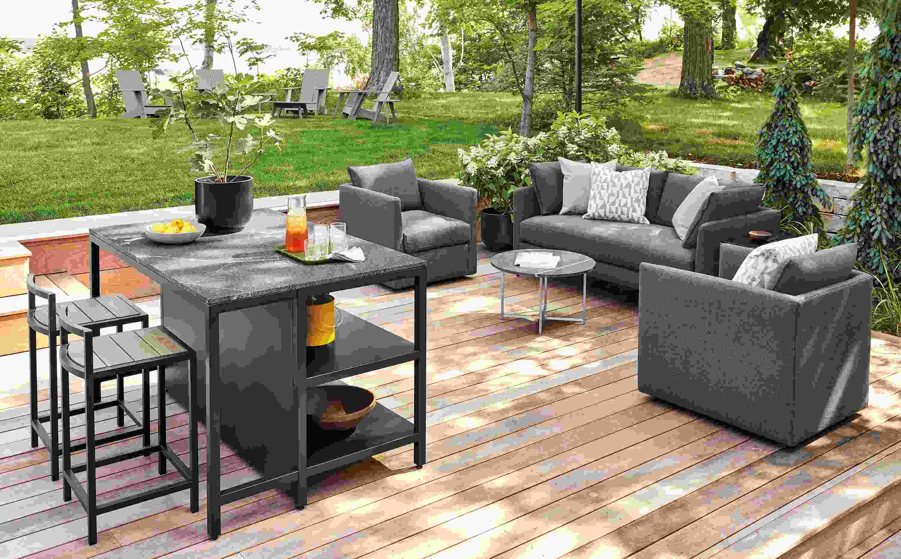 Outdoor space with parsons outdoor counter table, montego stools and Palm sofa in Mist Charcoal.