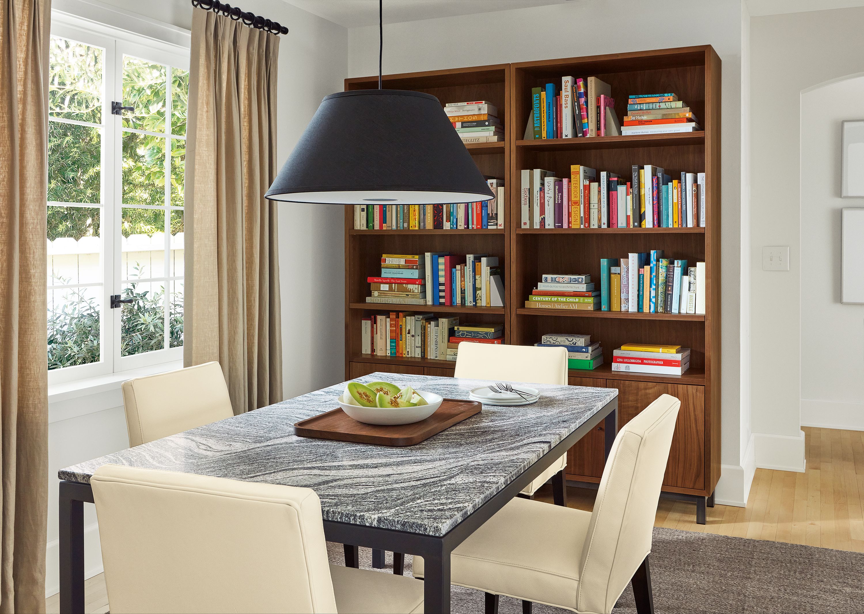 Dining room with Parsons table, Ava chairs, Luisa pendant, Copenhagen bookcases.