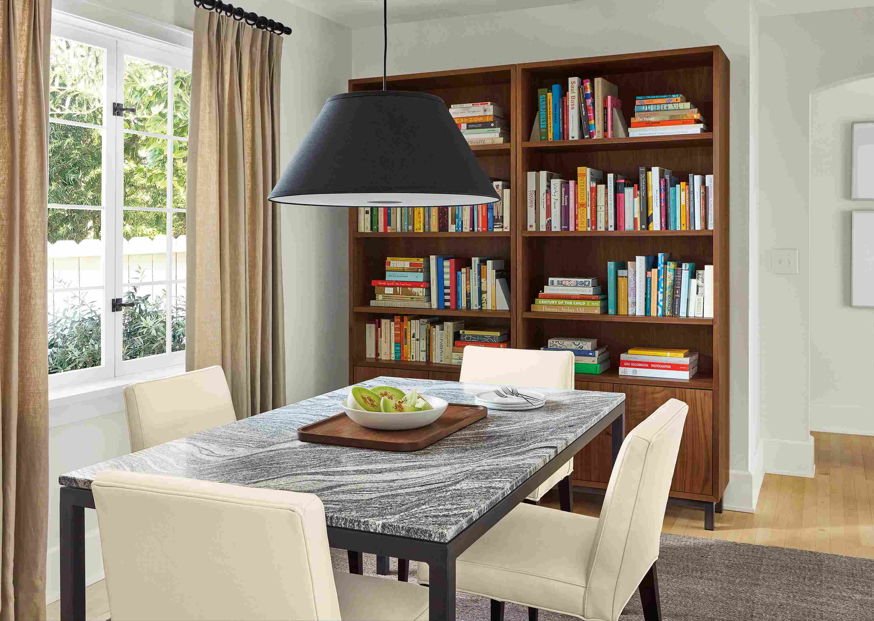 Dining room with Parsons table, Ava chairs in pesaro ivory, Luisa pendant and avilia rug in foxhound.