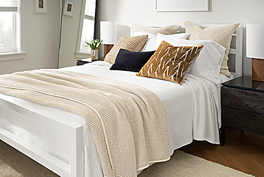 detail of parsons bed with loren coverlet, branch throw pillow, whitmore coverlet.