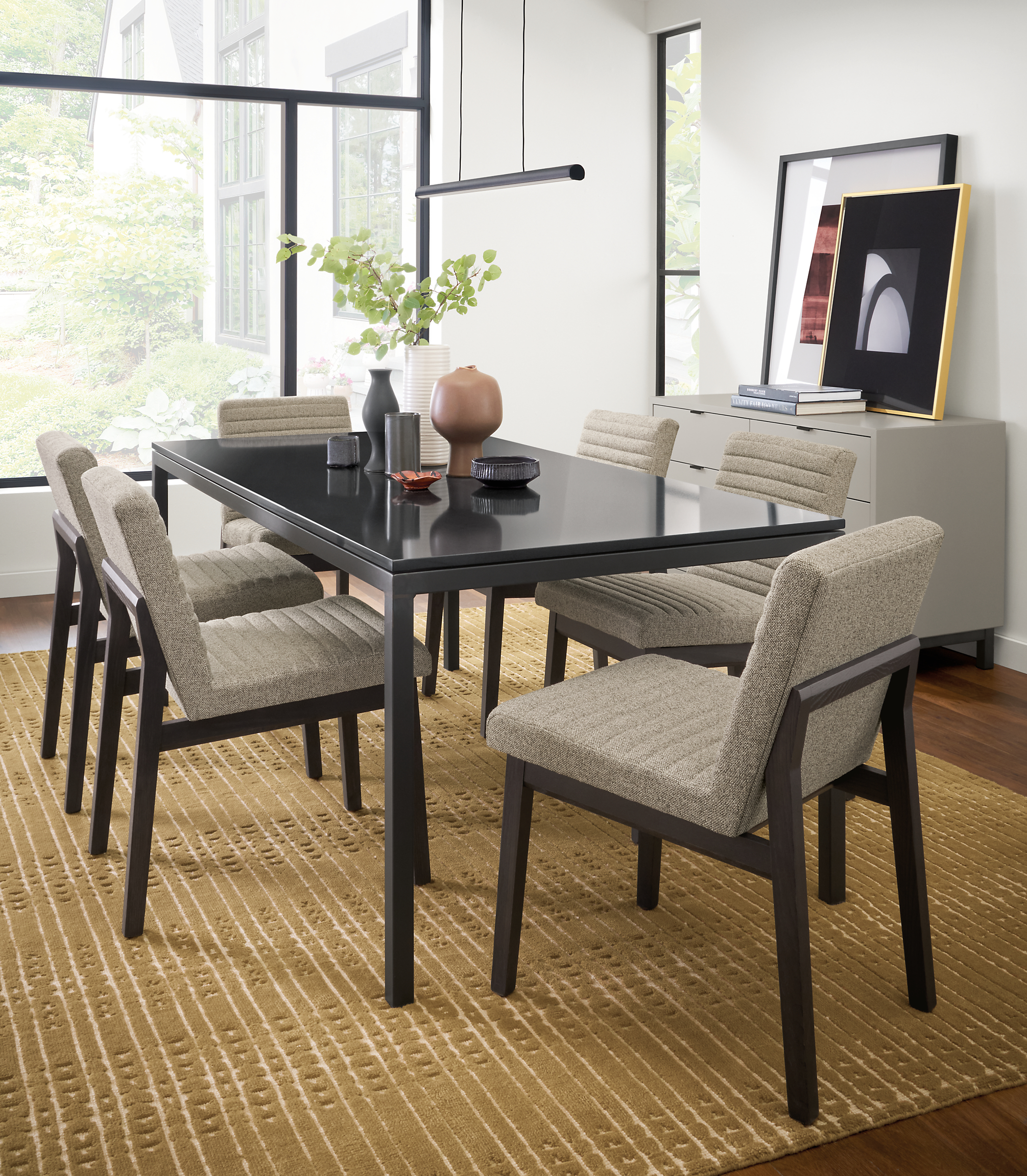 Dining room setting with Parsons 72-wide table in natural steel with black quartz top and Olsen side chairs in Tatum grey..