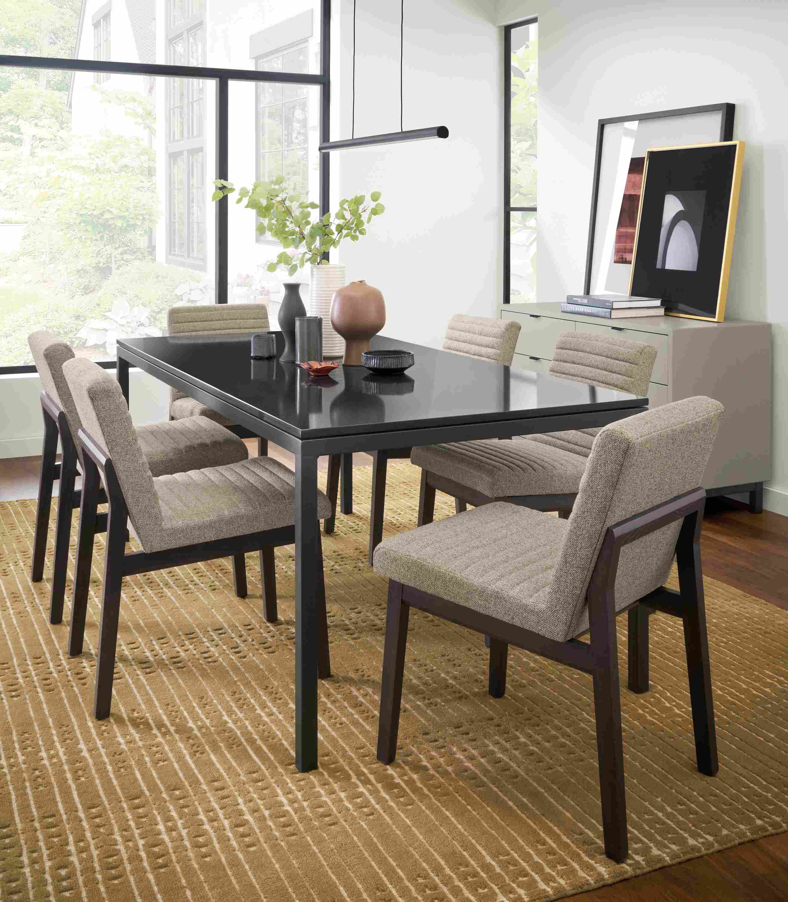 Dining room setting with Parsons 72-wide table in natural steel with black quartz top and Olsen side chairs in Tatum grey.