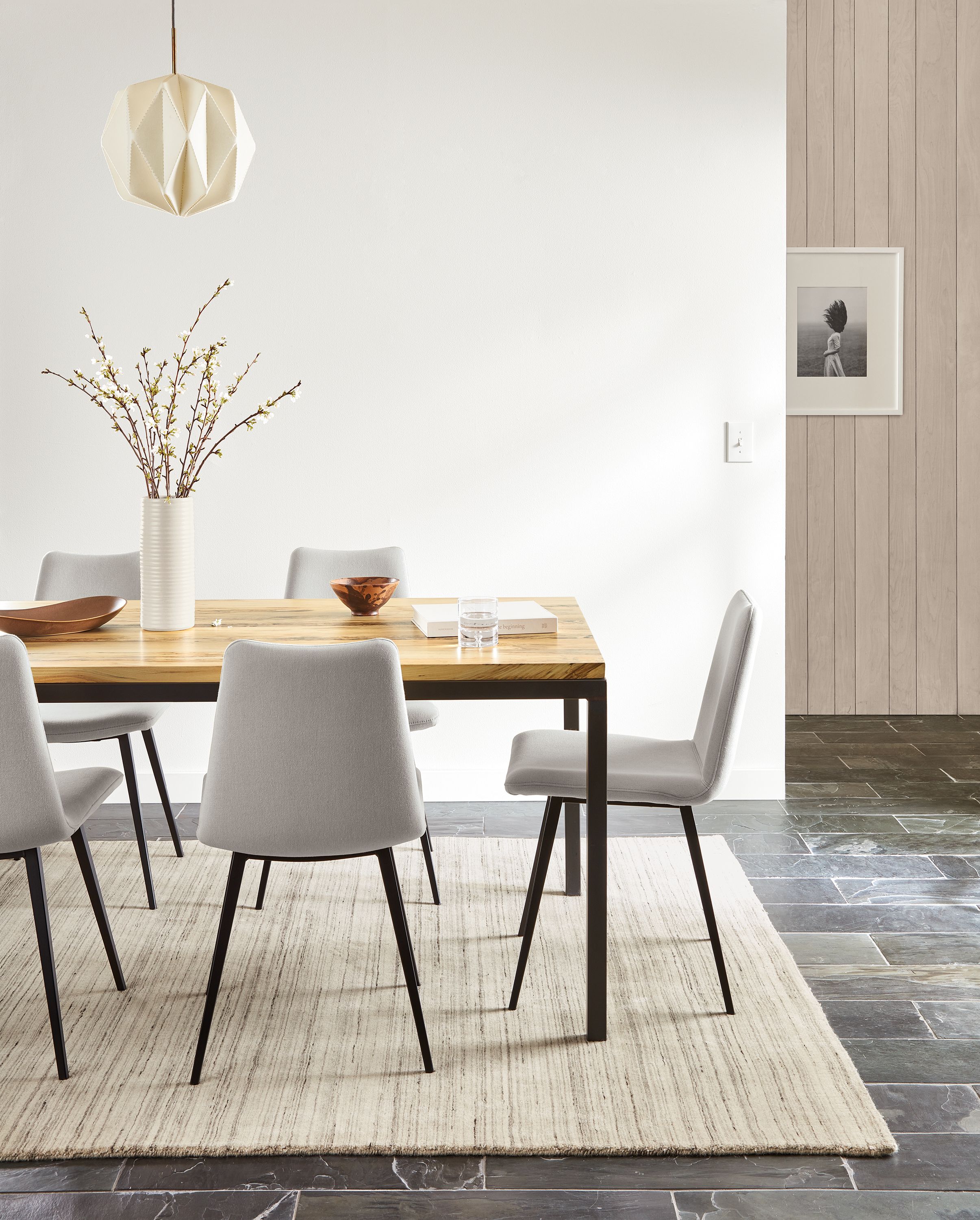 dining room featuring parsons dining table in natural steel with sugarberry top and arthur dining chairs in grey.