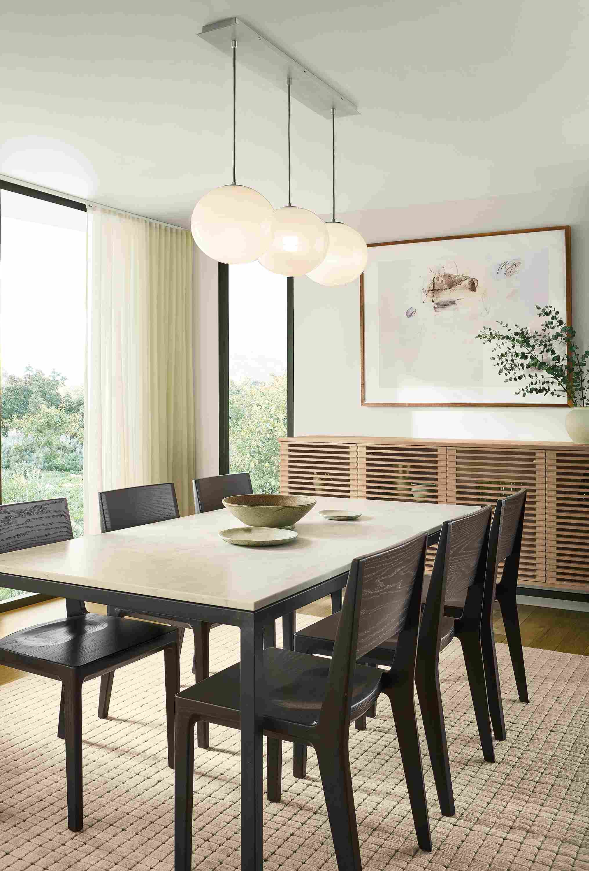 Dining room with Parsons table in natural steel and Mahal Quartz, 6 Haven side chairs in charcoal on oak and Safira rug in ecru.