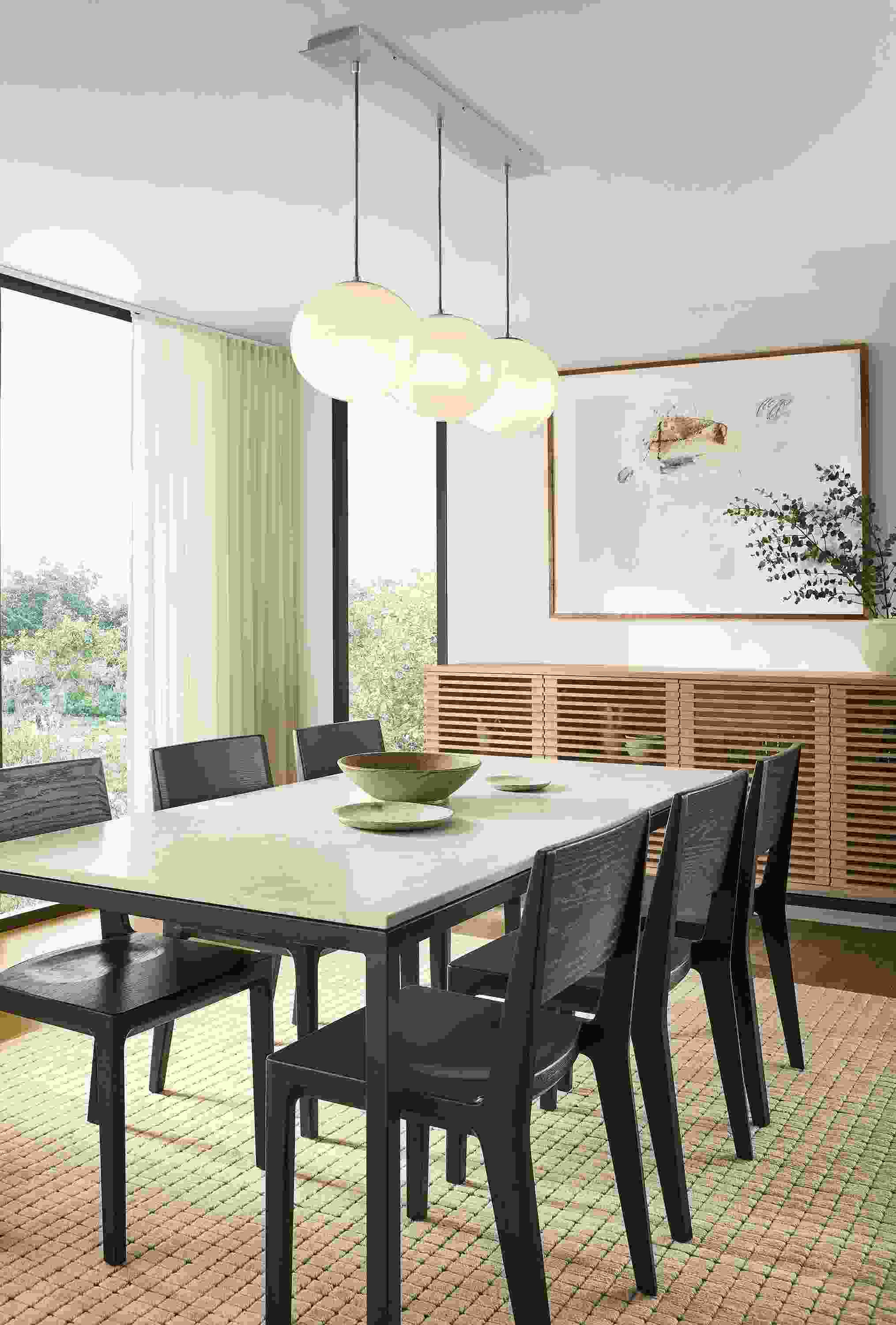 Dining room with Parsons table in natural steel and Mahal Quartz, 6 Haven side chairs in charcoal on oak and Safira rug in ecru.