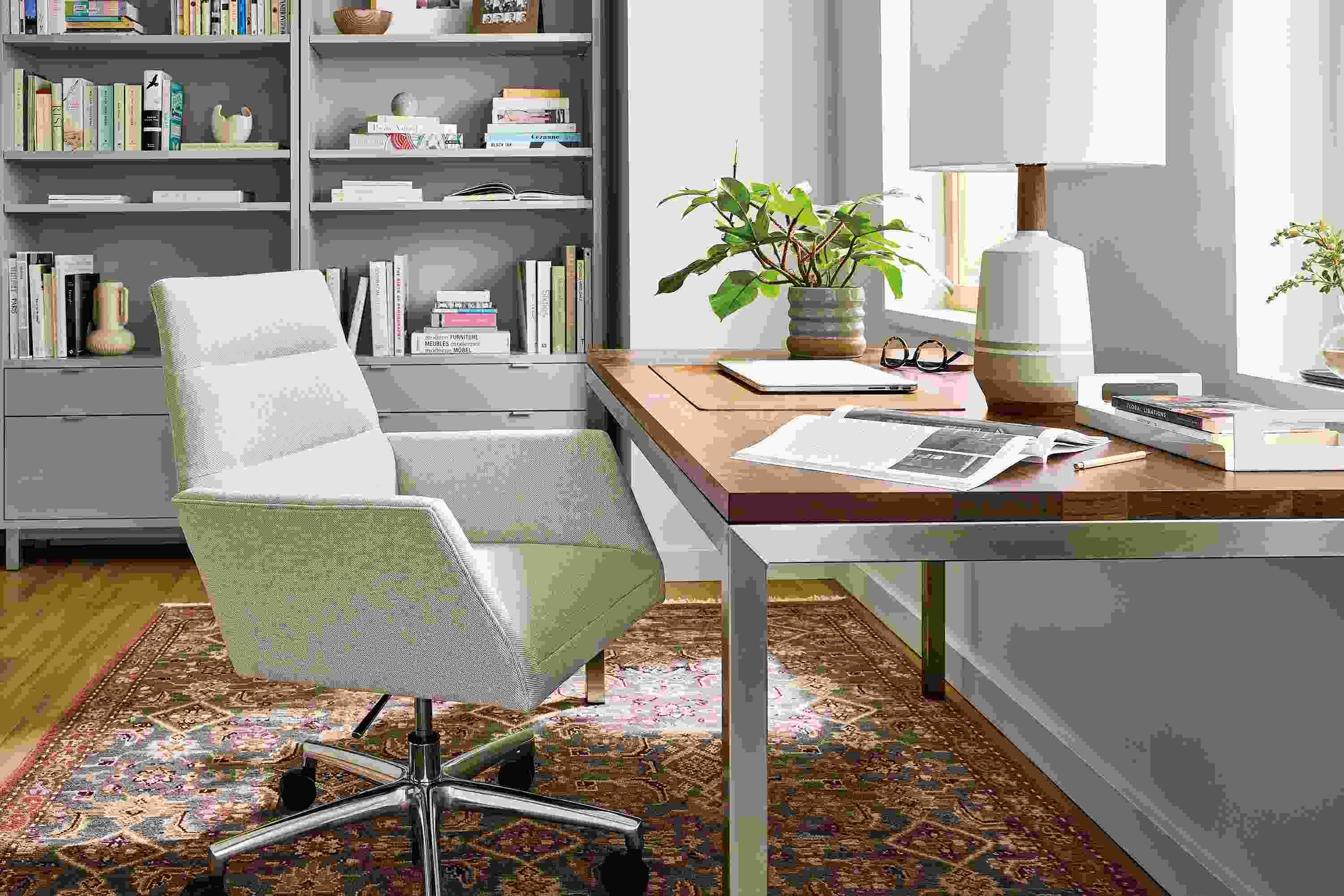 Home office with parsons table in stainless with walnut top, tenley chair in gino oatmeal and helena rug in slate.