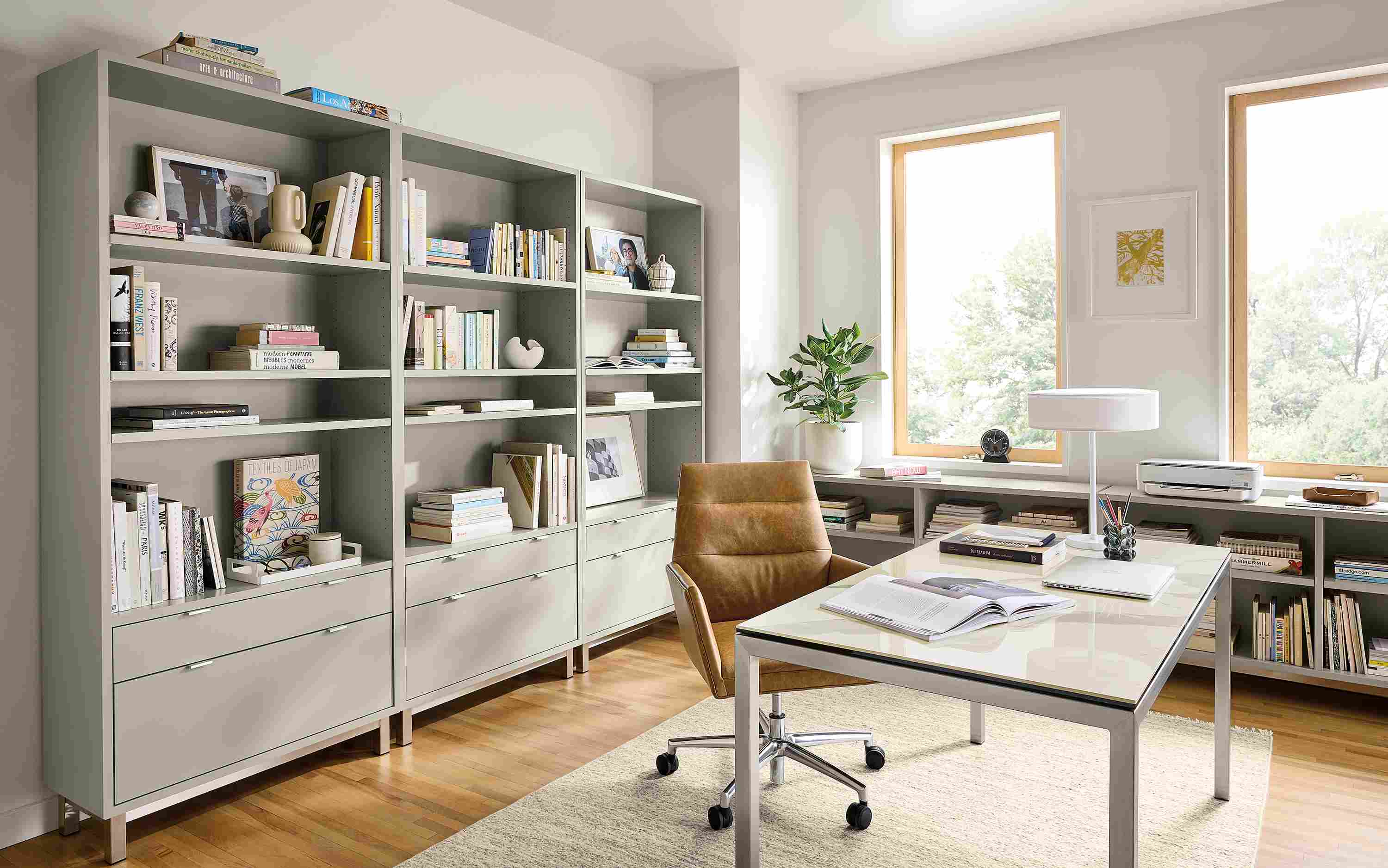 Office with parsons table in stainless with marbled white ceramic top and tenley office chair in palermo camel leather.