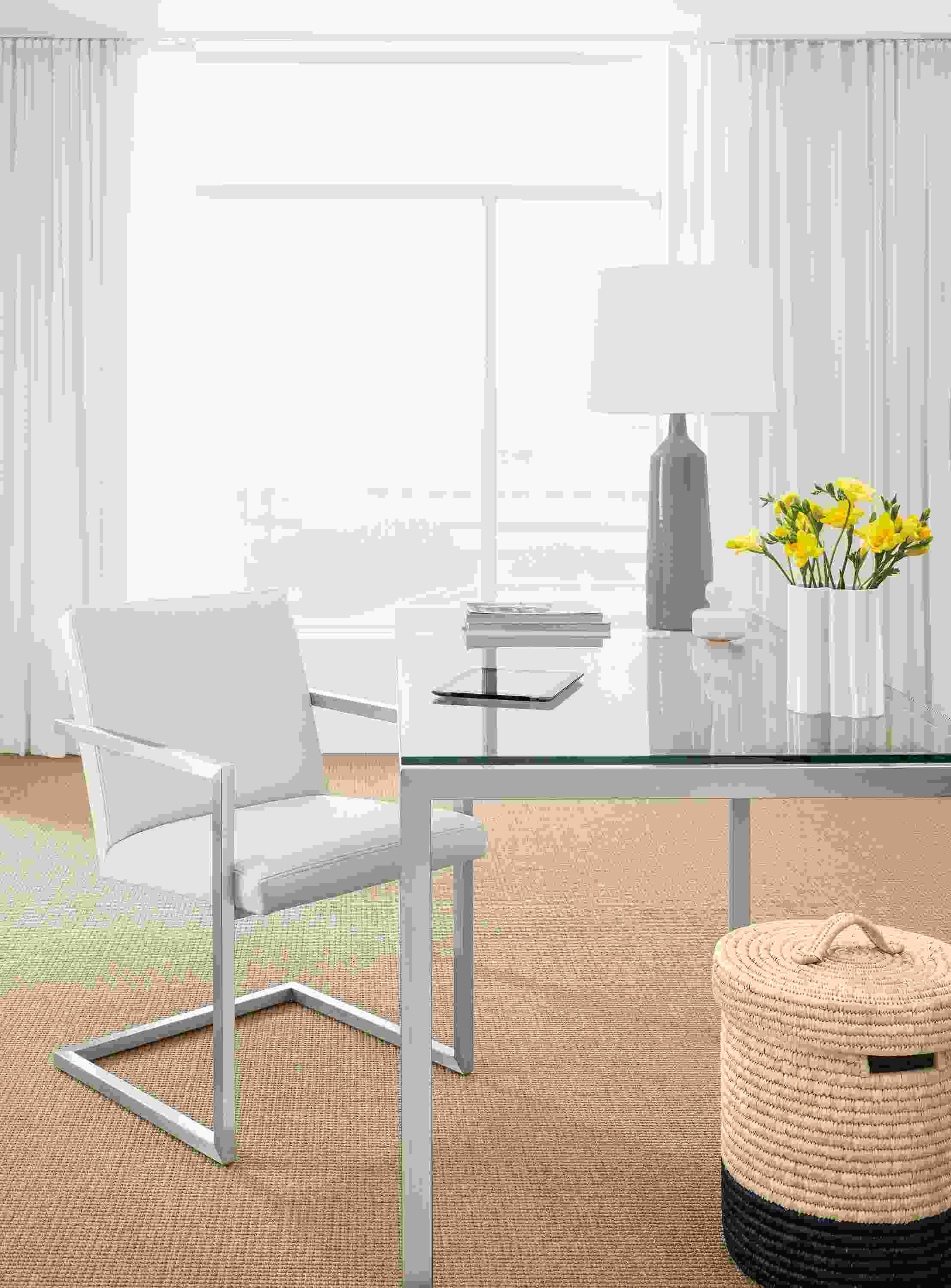 Office with Lira arm chair in Laino bone leather and Parsons table in stainless steel with glass top.