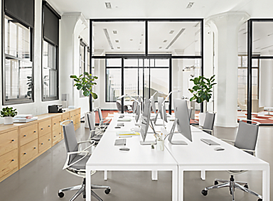 Business Interiors setting with Parsons 60-wide table with legs and plimode office chairs.