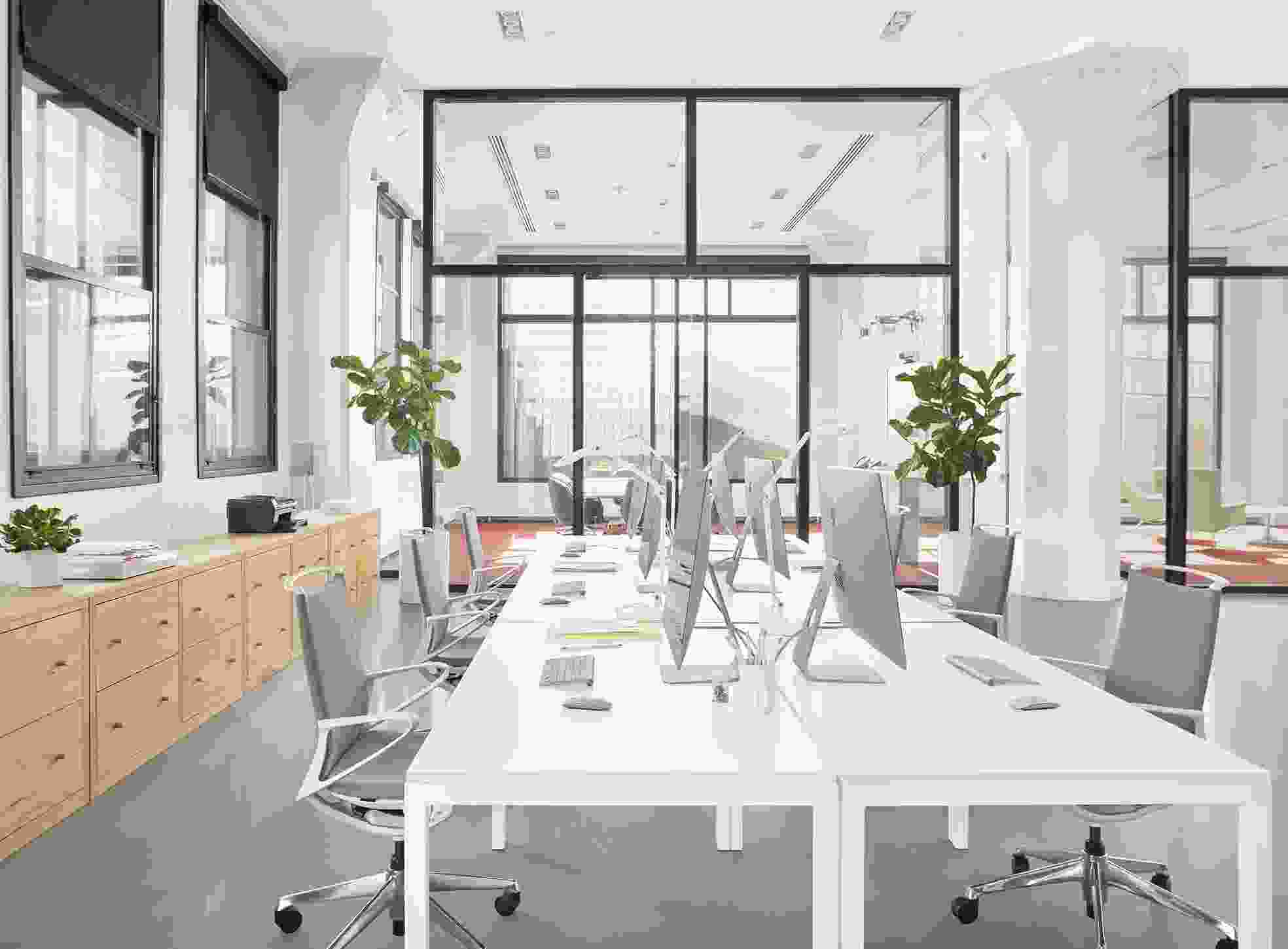 Business Interiors setting with Parsons 60-wide table with legs and plimode office chairs.
