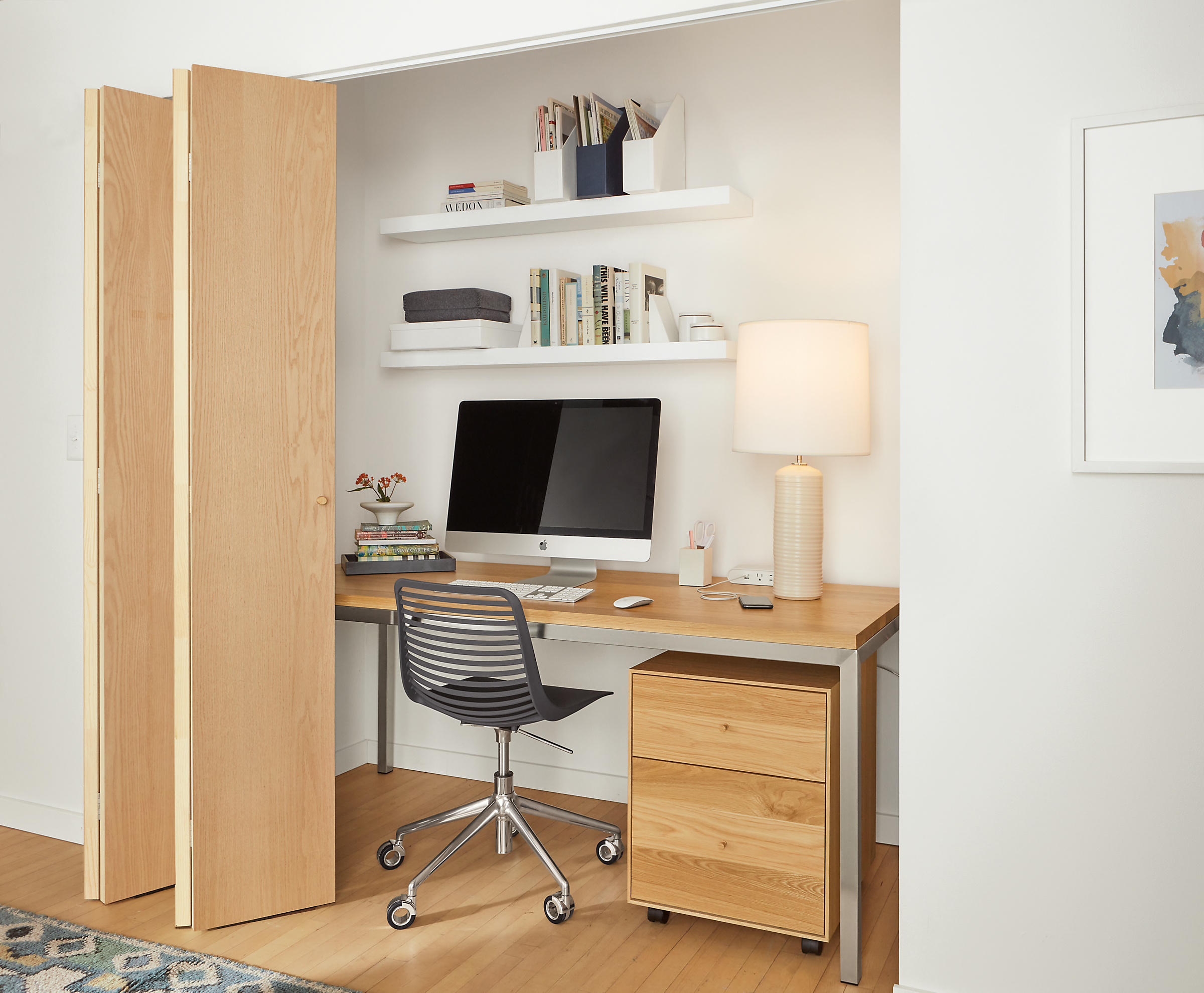 Office setting with 72-wide parsons desk with maple top and white float wall shelves.