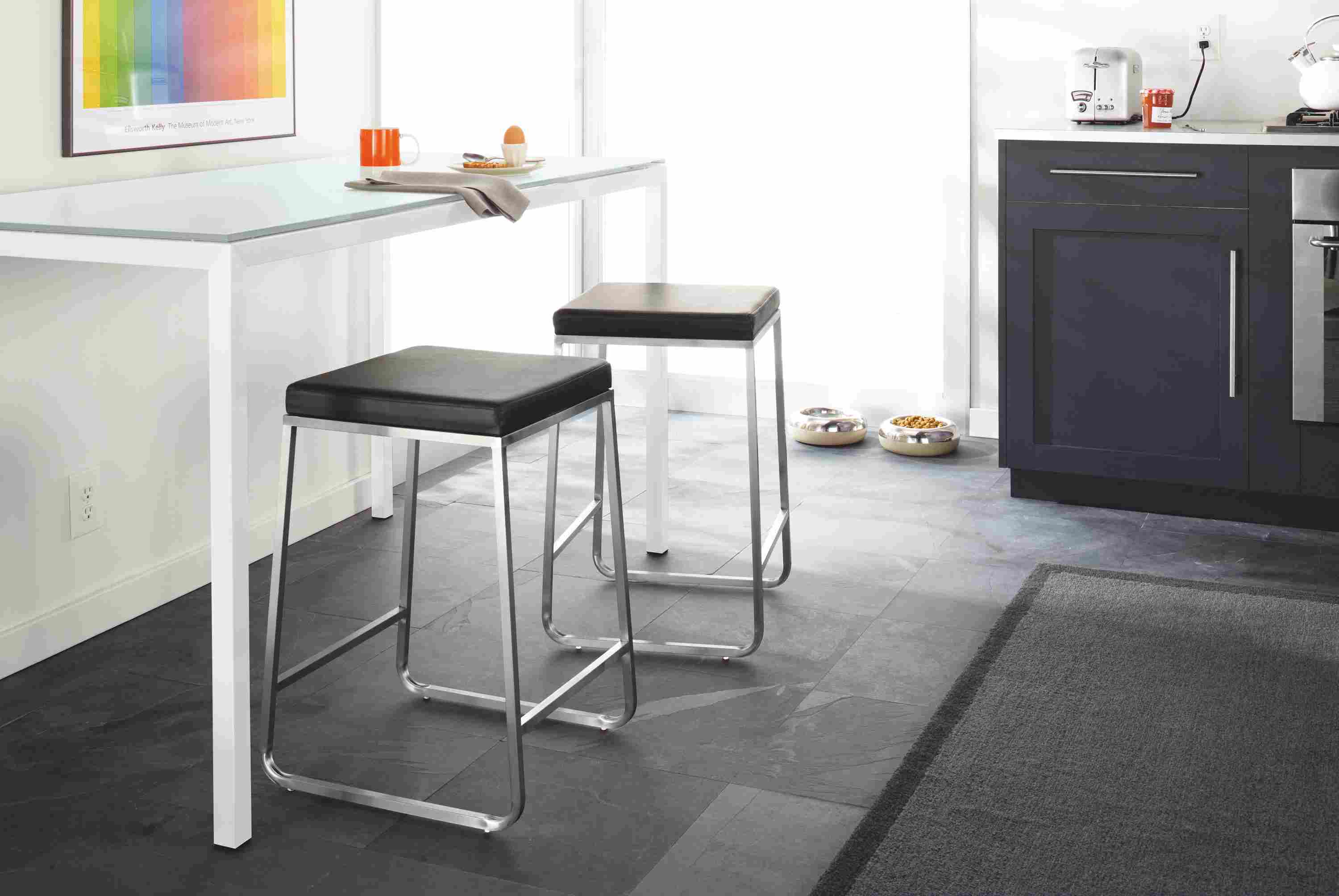 Kitchen setting with parsons 35-high counter table in stainless steel and collins counter stool in pstel leather.