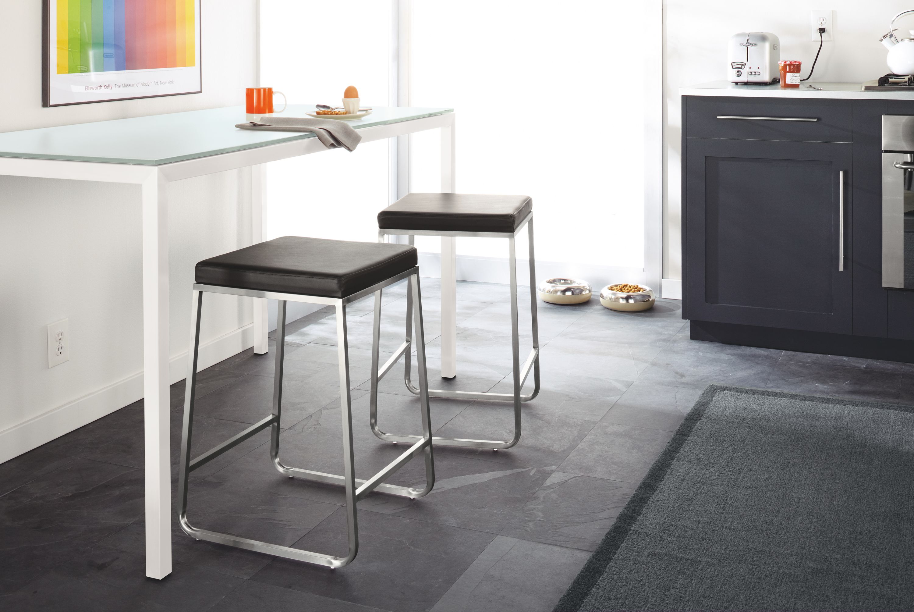 Kitchen setting with parsons 35-high counter table in stainless steel and collins counter stool in pstel leather.