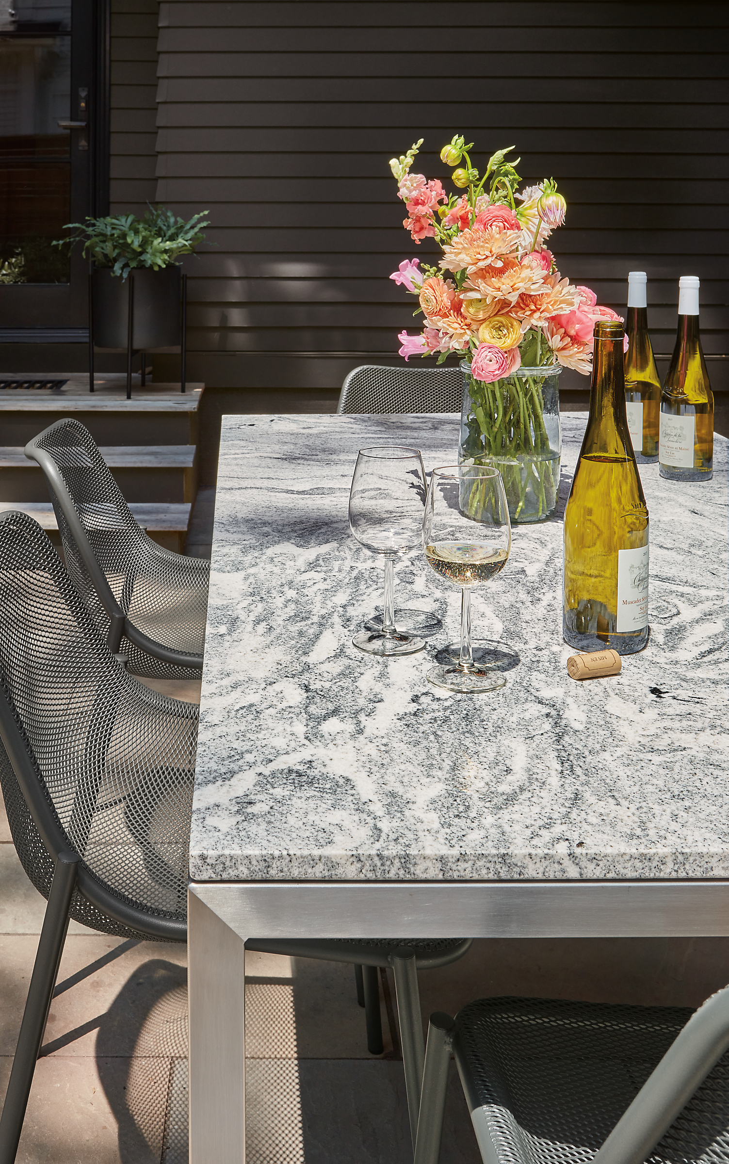 Outdoor setting with parsons 72-wide table with Soleil side chair in graphite.