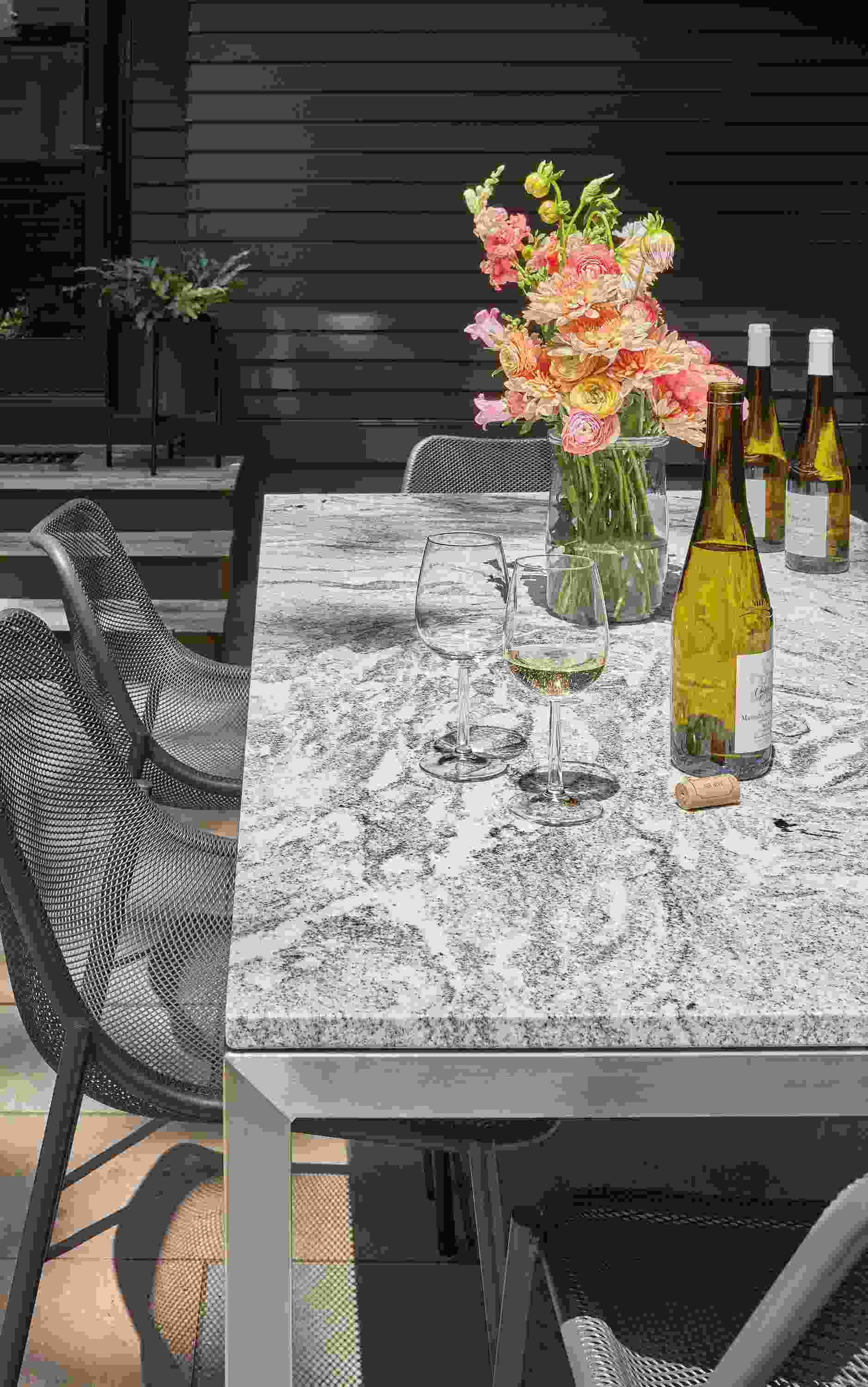 Outdoor setting with parsons 72-wide table with Soleil side chair in graphite.