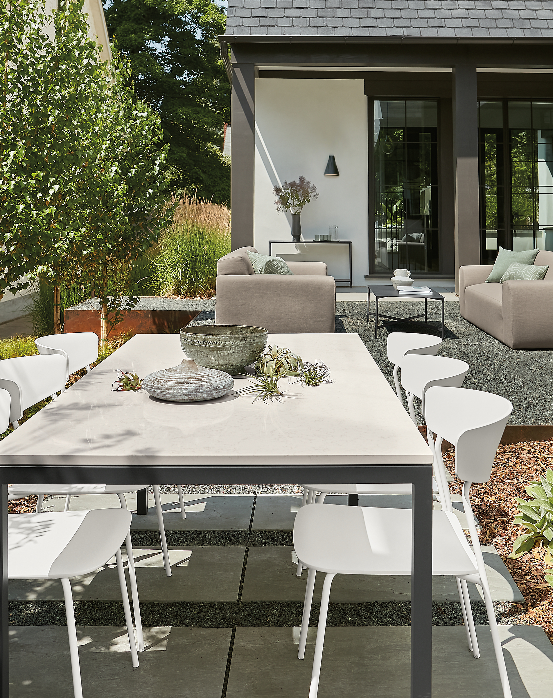 Outdoor space with parsons outdoor table, wolfgang side chairs, drift sofas in background.