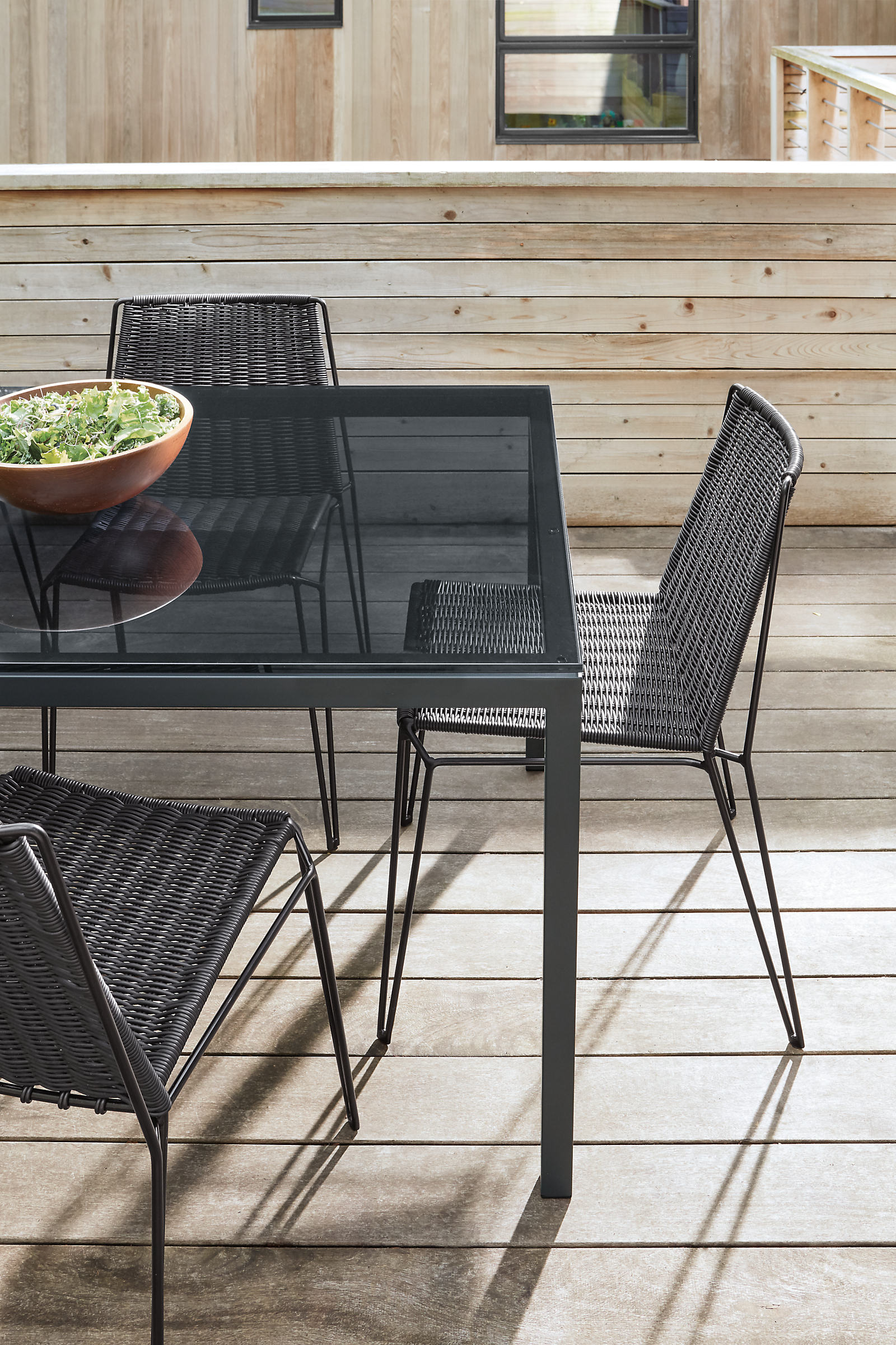Outdoor setting with parson 72-wide table with graphite legs.